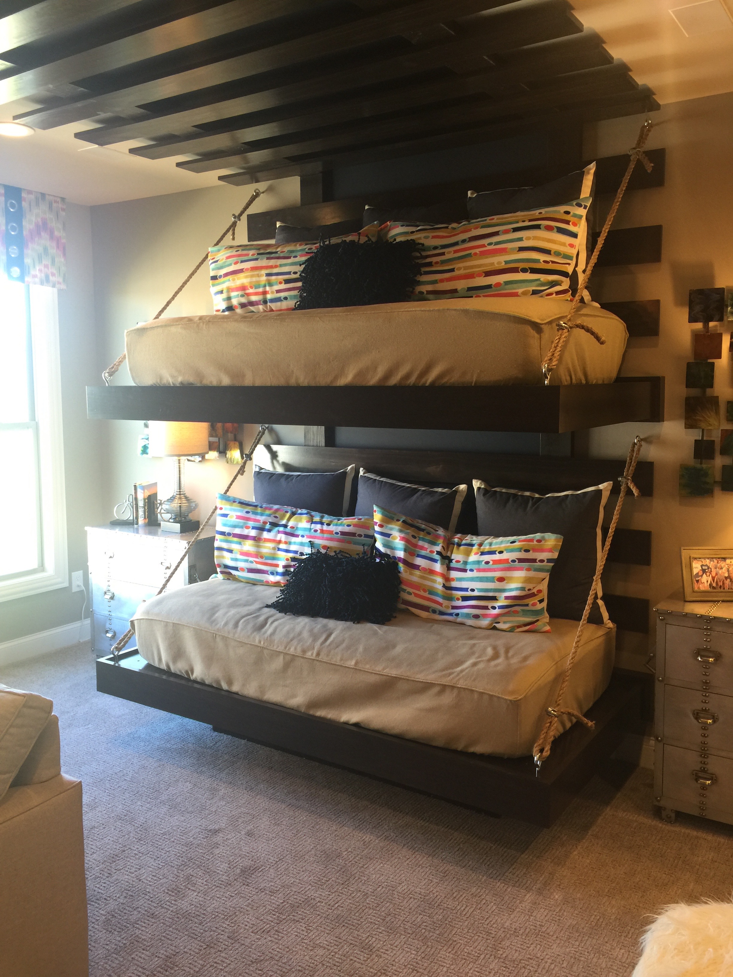 Alternative to traditional bunk beds?? Actually, this is a bonus room above the kitchen area, and was being used as a Media Room. Creative idea ~ and I can see my kids loving the top bunk to hang out and read a good book or write a story. 