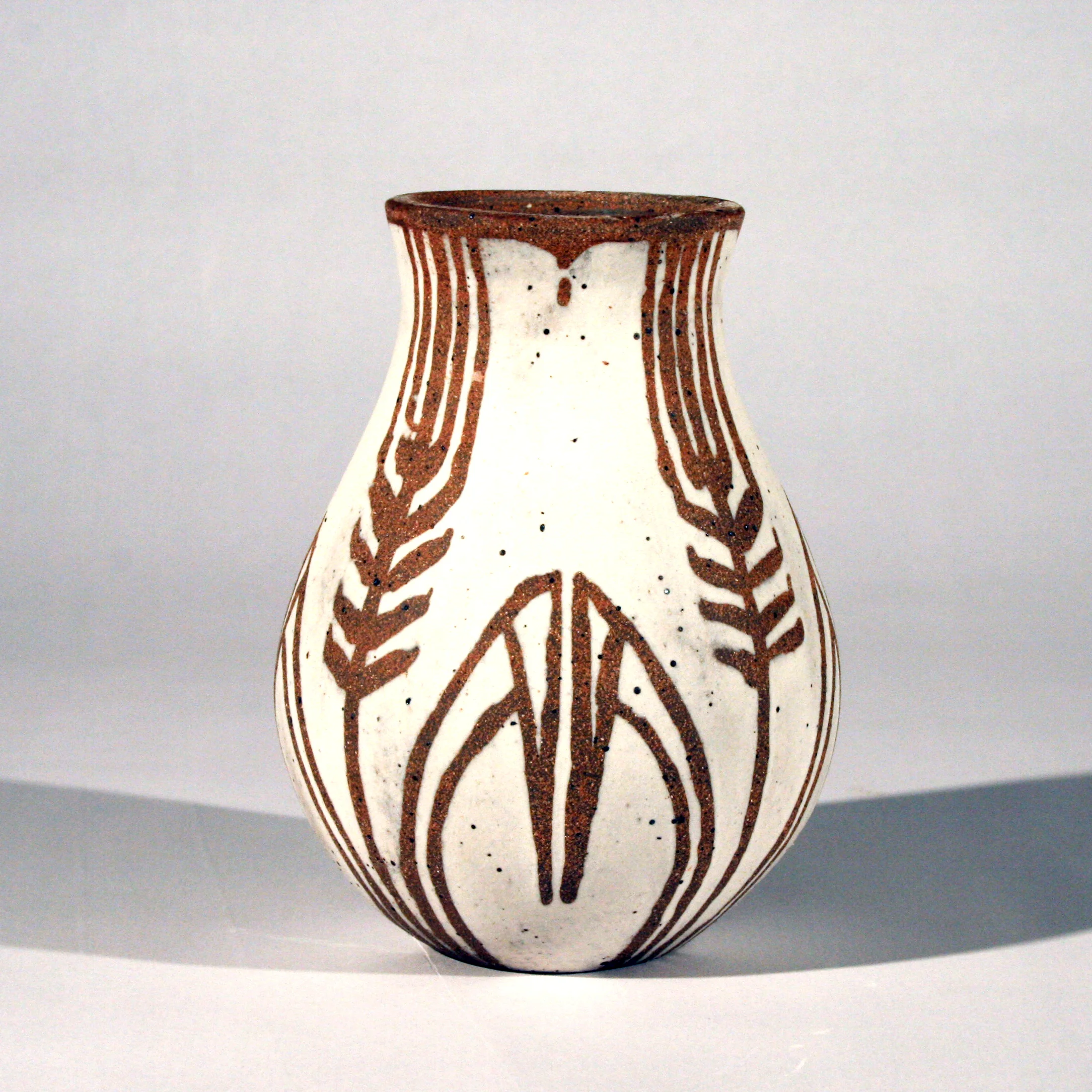 2013, Soda-fired red stoneware with porcelain slip overlay