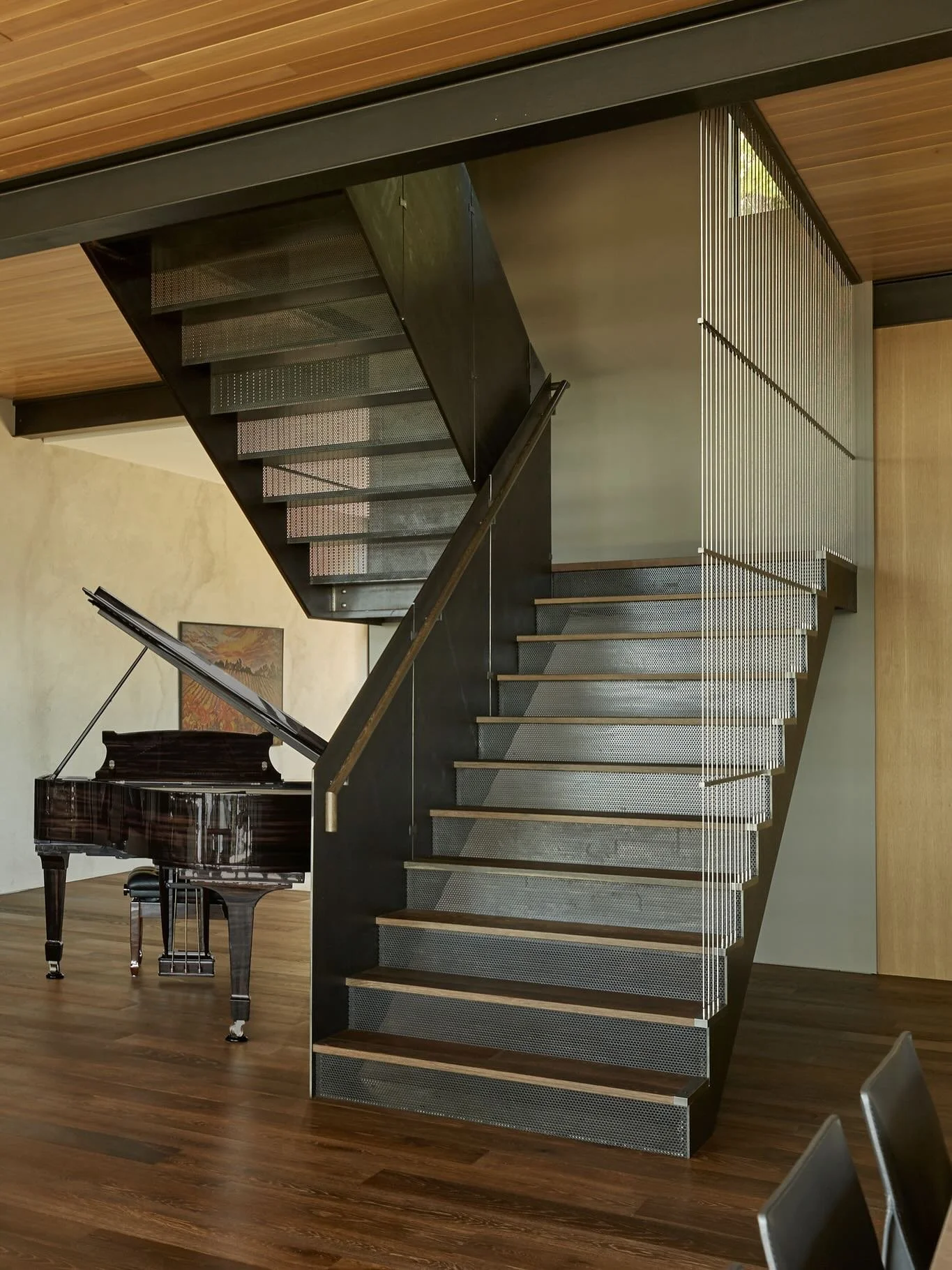At our #MCT_CorvusHouse, the great room opens to sweeping views of Lake Washington. To balance this outward focus, the stair takes on the role of a central art piece - hot rolled blackened steel, stainless steel cable guardrails, and warm oak accents