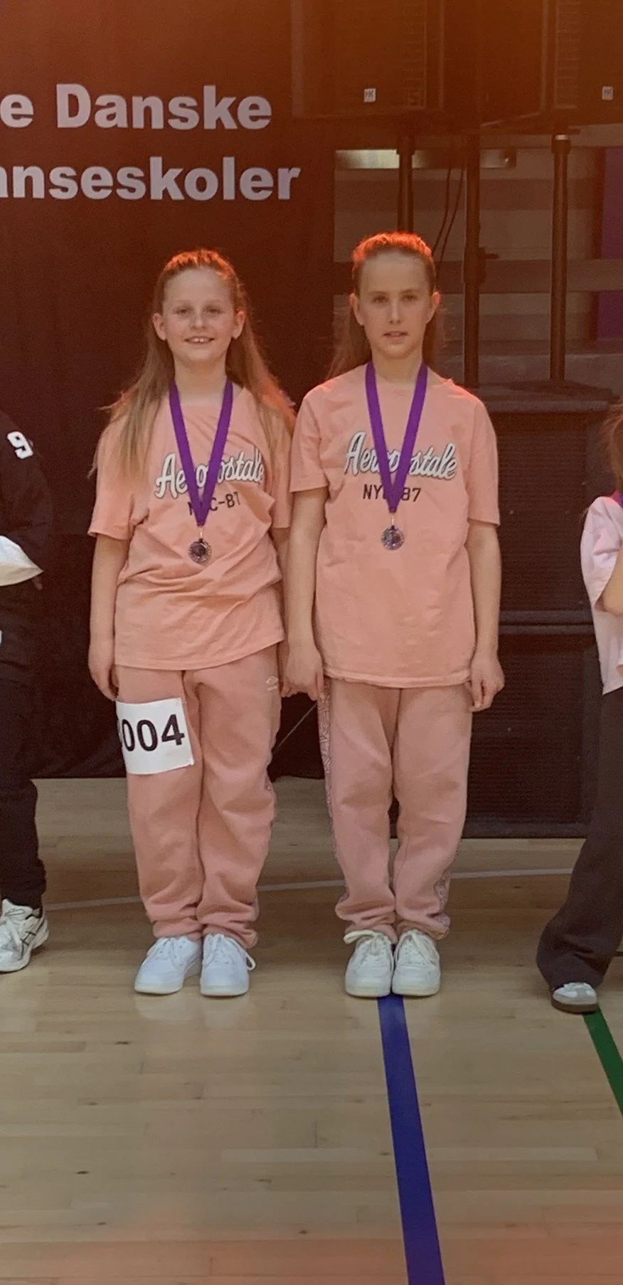 Hiphopduo fra Dansefeber i Viby J med medaljer ved dansekonkurrence, i laksefarvede dragter