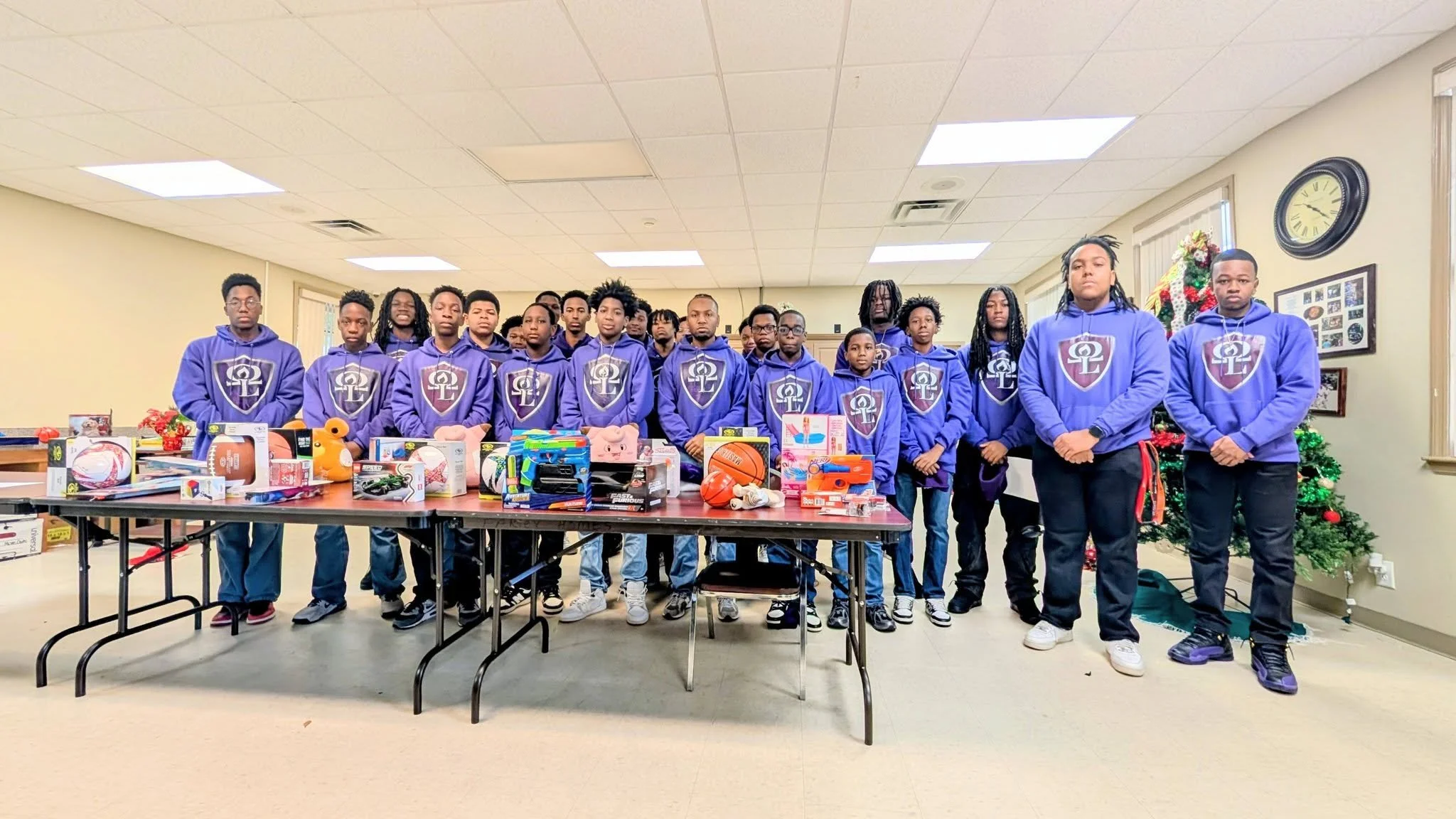 Young men of the Omega Lamplighters donate toys ahead of the Christmas holiday