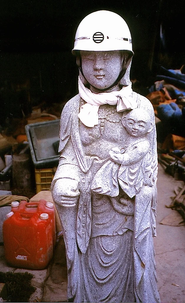 13-18 Religious statue (Jizo) equipped with helmet and gasoline can