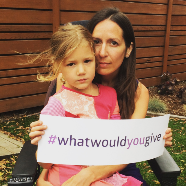 Scarlett holds the #whatwouldyougive sign in the photo that launched the campaign / photo credit Rob Goulding