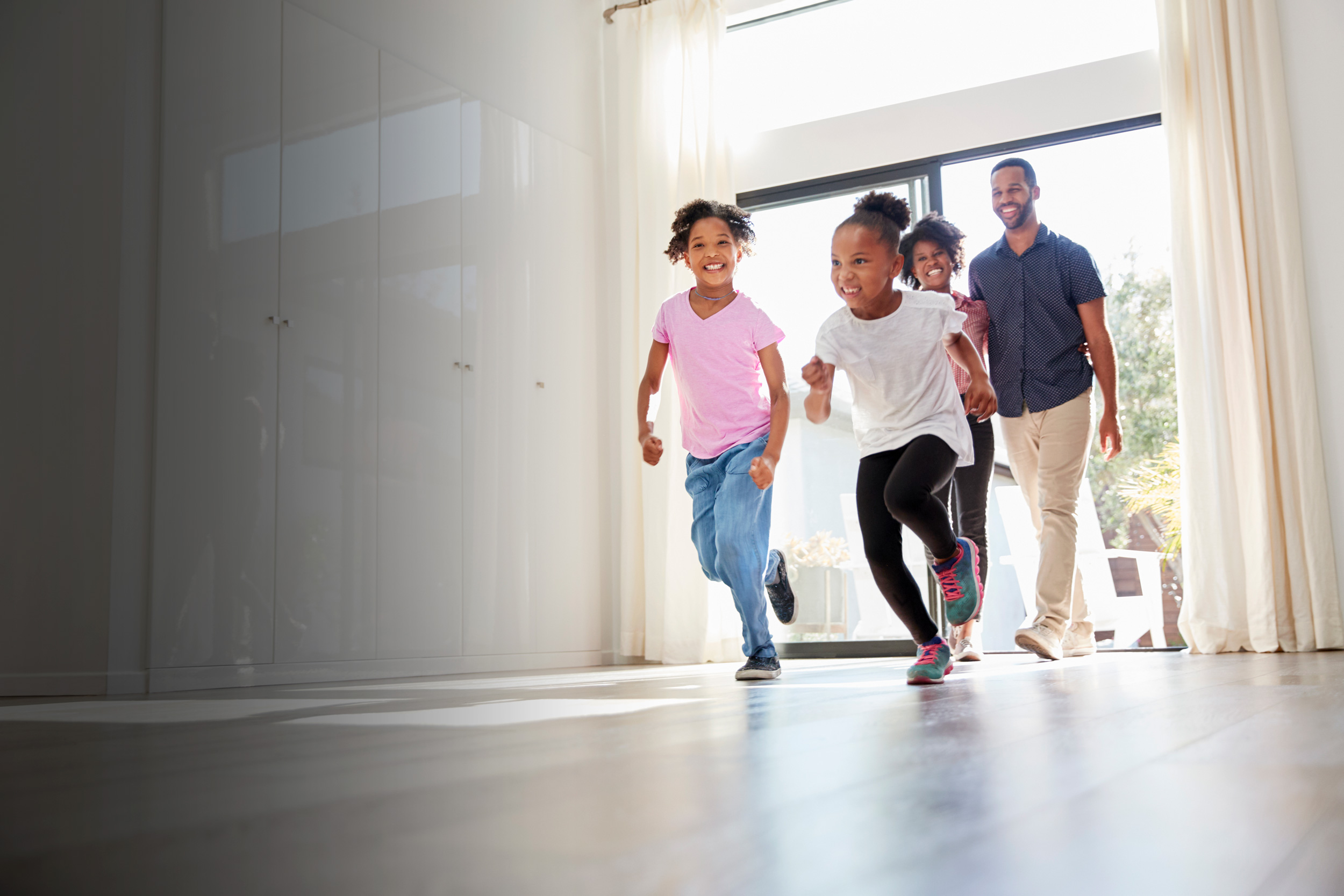 excited-family-exploring-new-home-on-moving-day-TMVPUBJ_sm.jpg