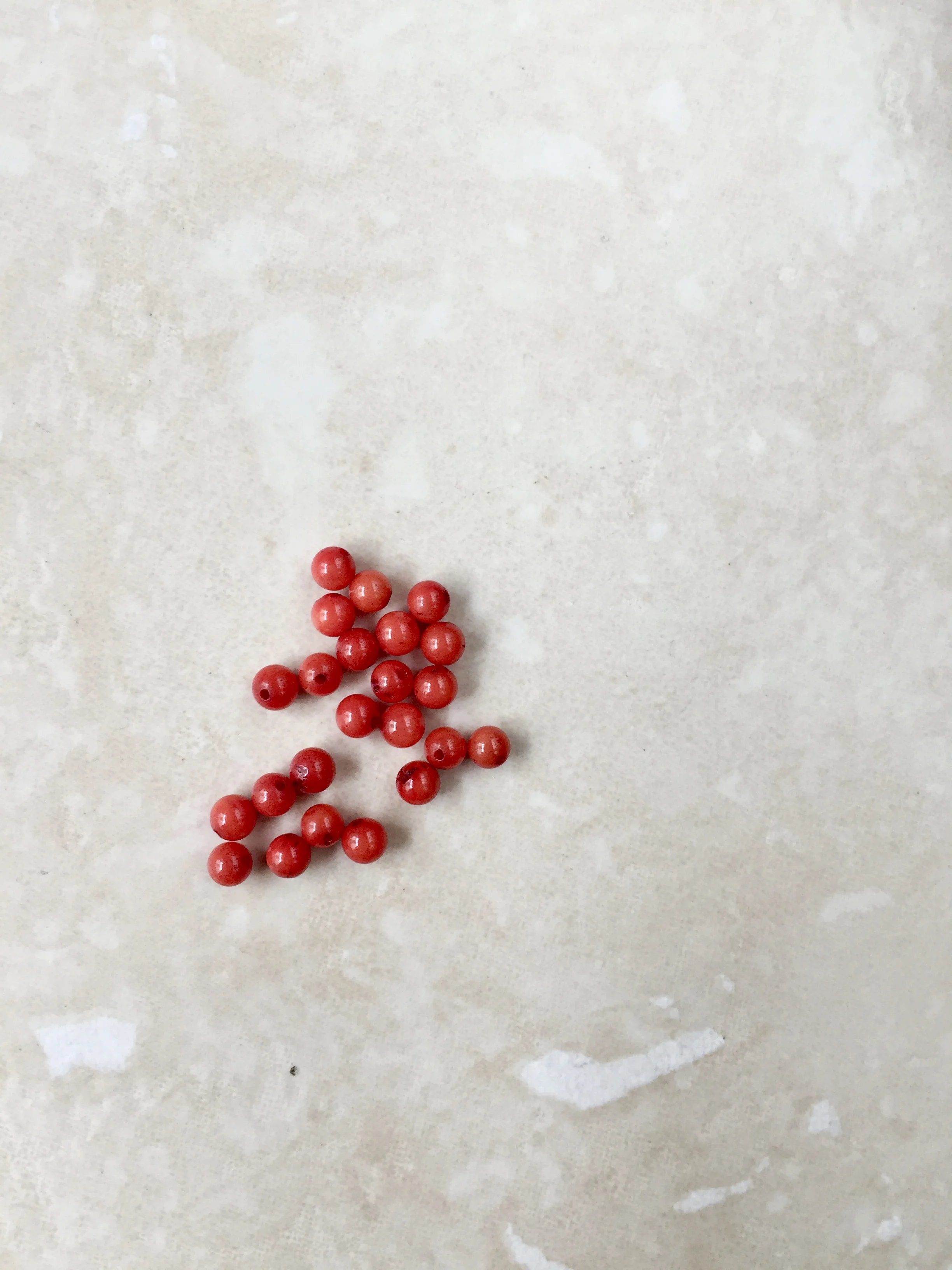 Tiny red coral beads.