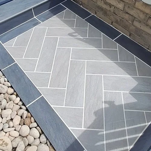 Short porcelain herringbone path accessing the clients home.