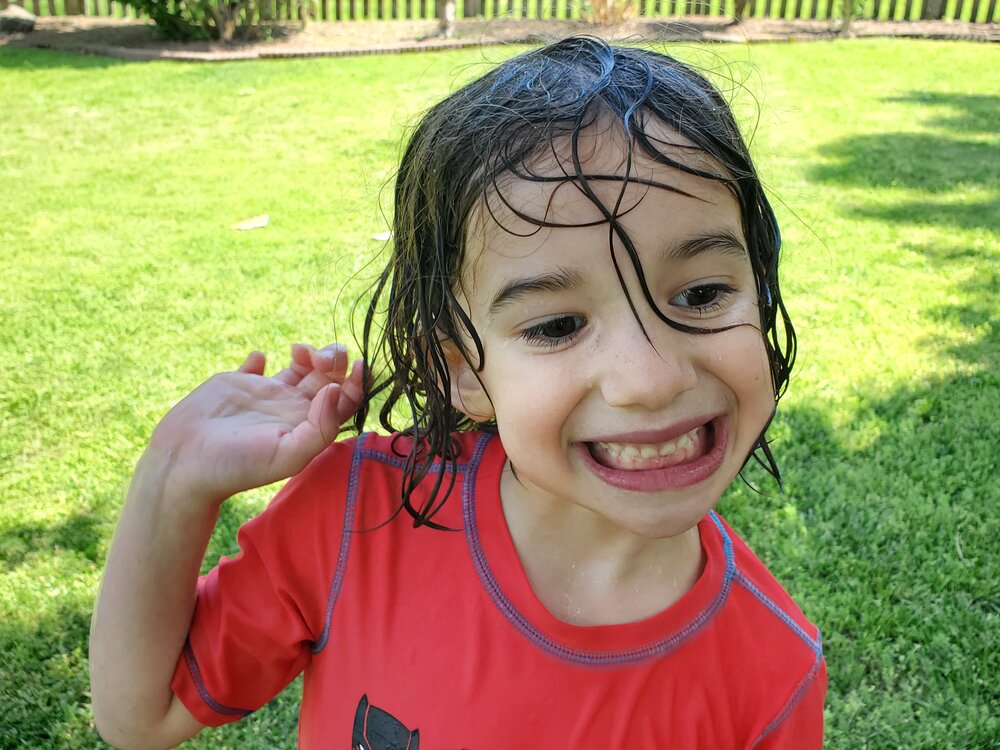 Cece likes to play in the sprinklers