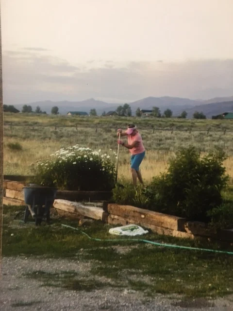 My mom working in one of her many gardens.