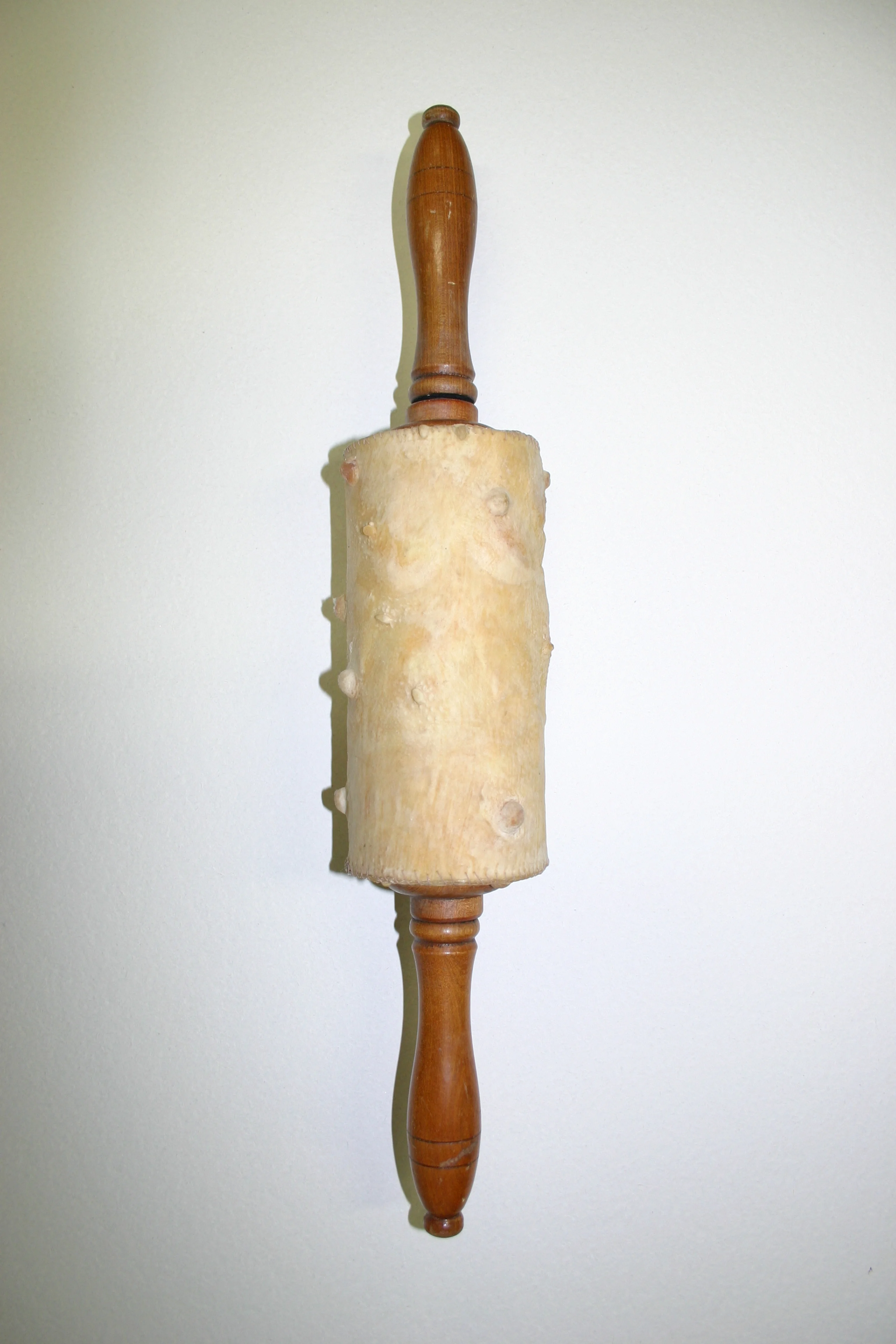   Nipple roller.  &nbsp; Stitched cast latex,&nbsp;wood 