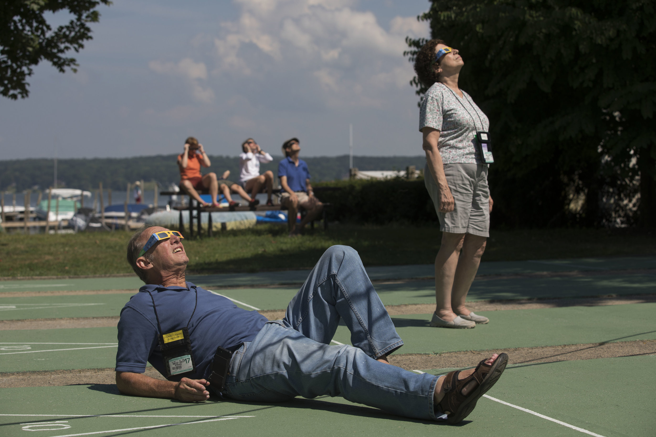  Jeff Hirshberg, left, and Janet Ostrow watch the solar eclipse on Monday, Aug.&nbsp;21, 2017.&nbsp;At Chautauqua, the moon reached its peak coverage of the sun of 77.4%&nbsp;at 2:34 p.m. 