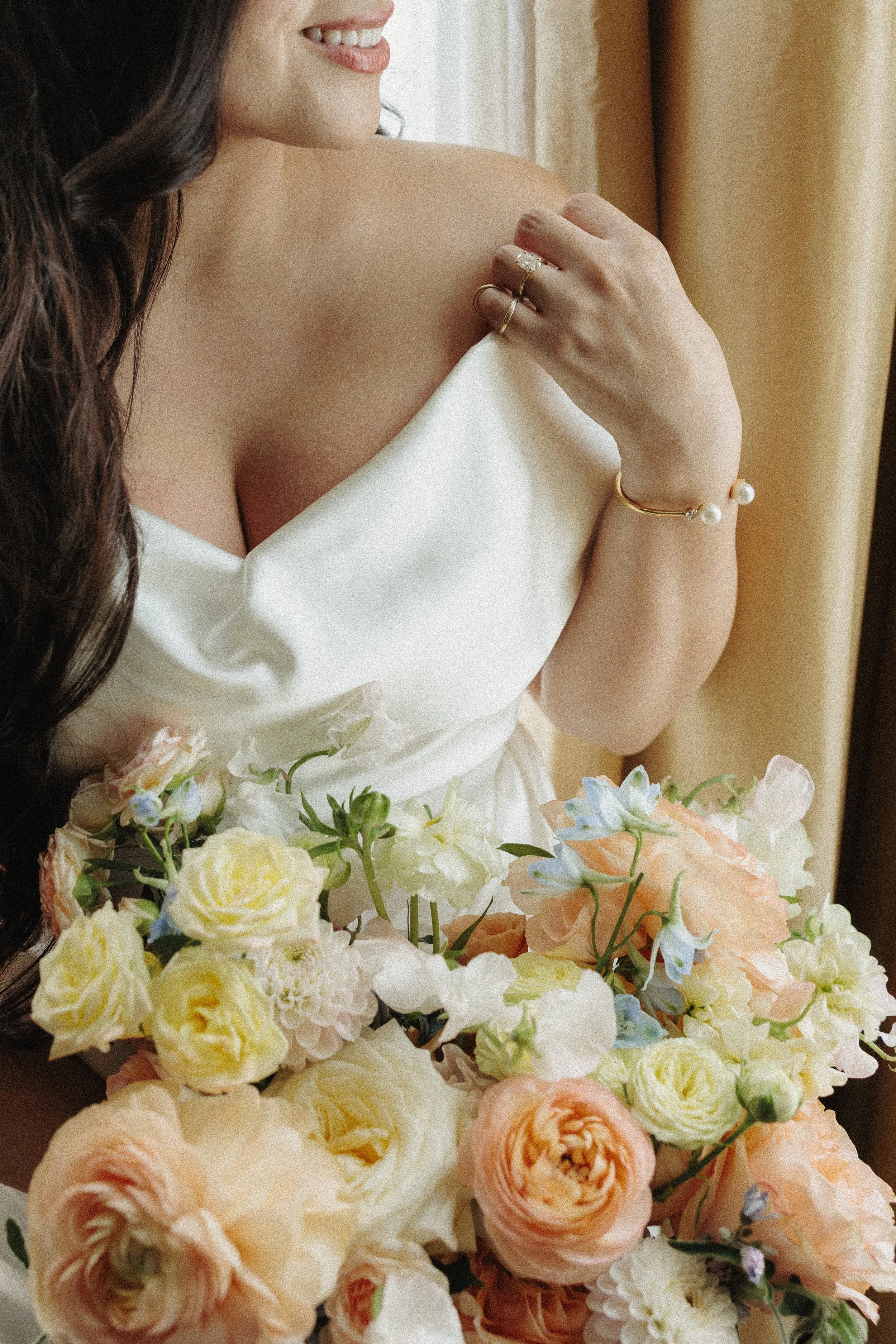 elegant editorial close up of a bride with a rose bouquet
