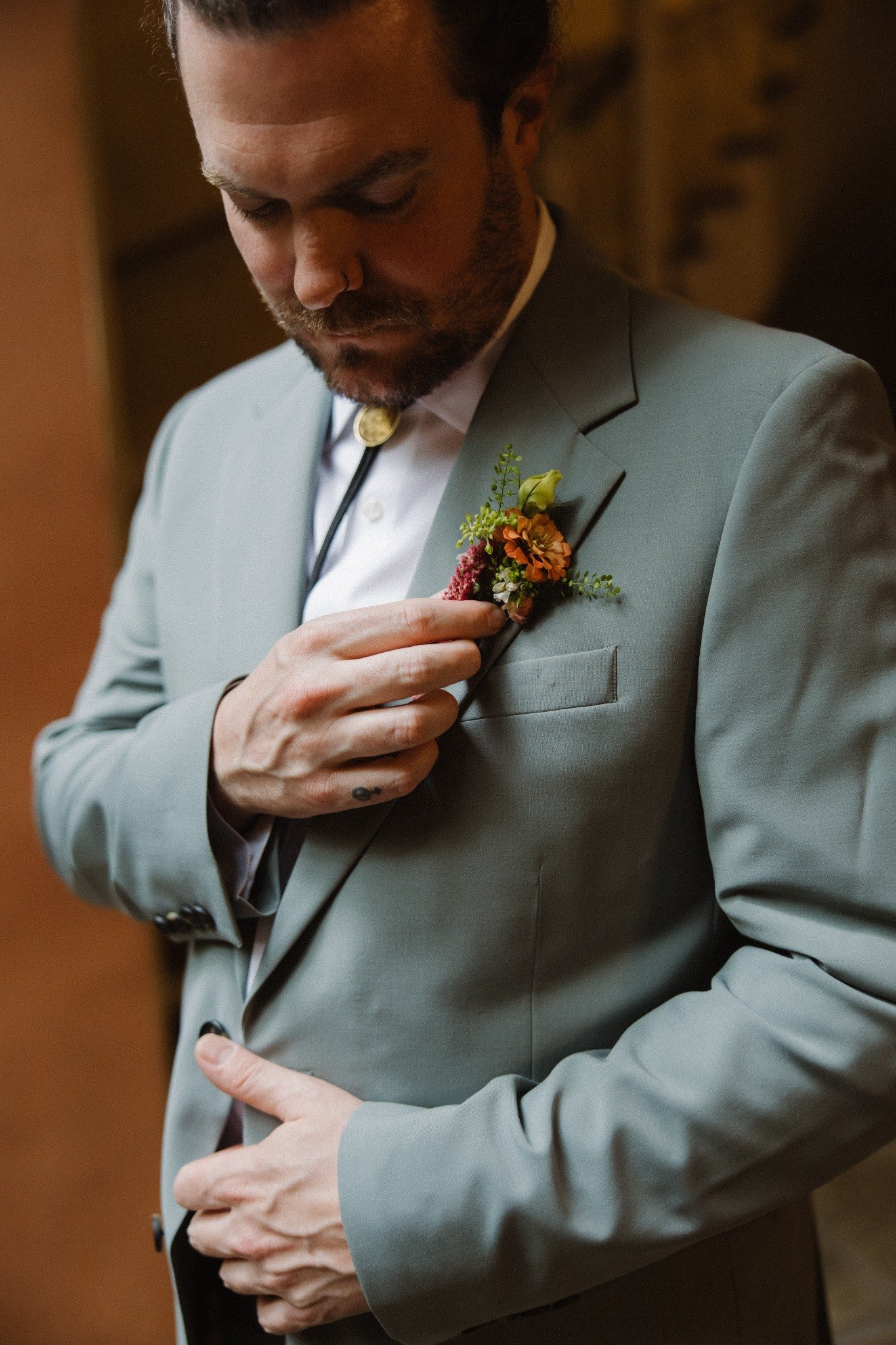 Groom portrait with floral boutonniere at the New Orleans Pharmacy Museum