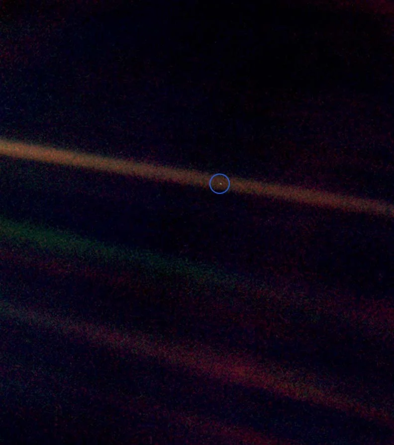 Pale Blue Dot, a photograph of planet Earth taken on February 14, 1990, by the Voyager 1 space probe from a record distance of about 6 billion kilometers (3.7 billionmiles, 40.5 AU ), as part of the Family Portrait series of images of the Solar System .