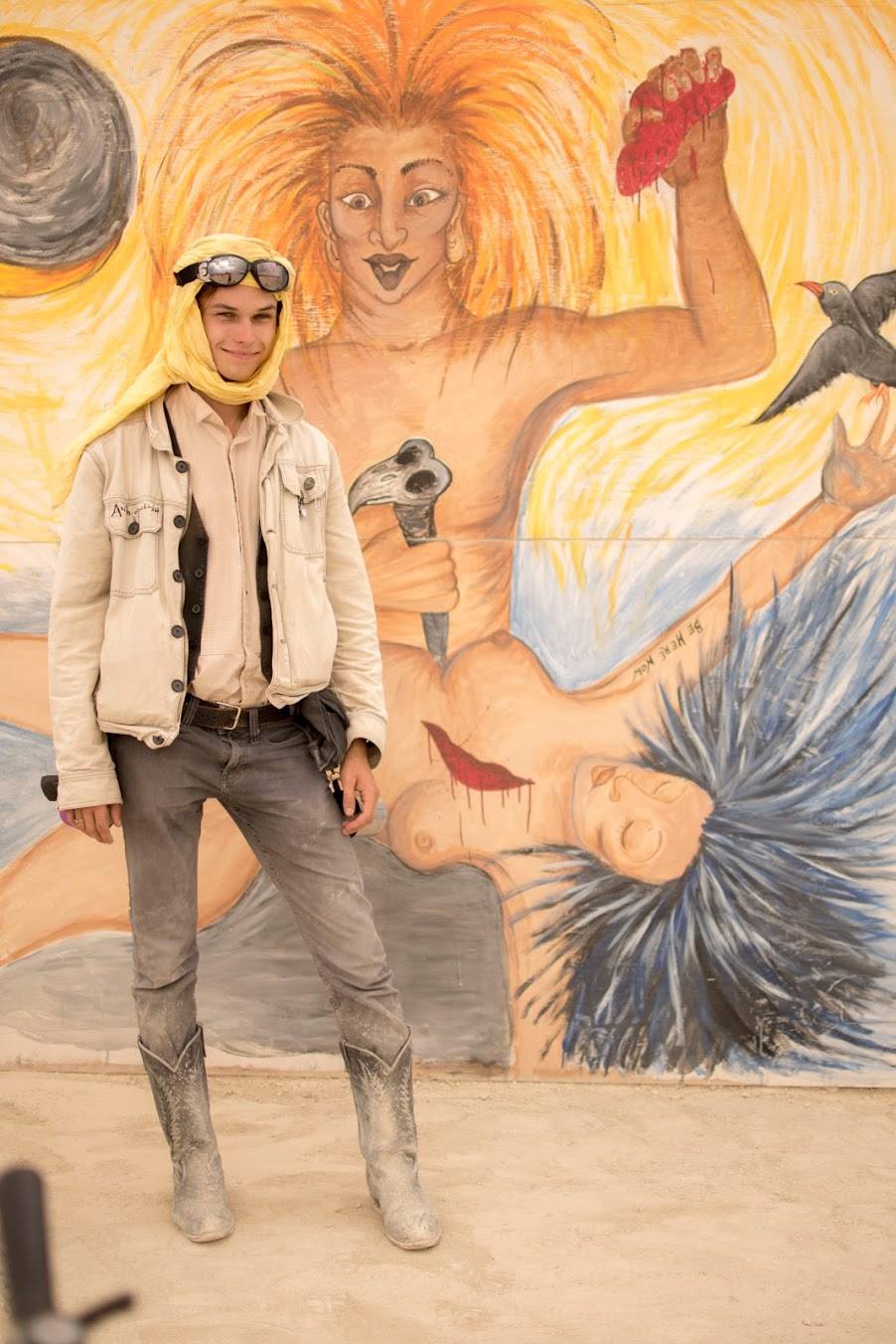 Myself, exhausted in front of one of the murals at Center Camp that I desperately hoped was a joke. Note the Ram Dass quote on the arm, and the fact that it wasn't actually an Aztec reference. Photo by Becca Levy.