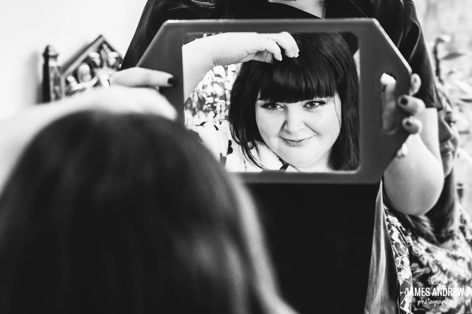 bride looking in mirror hairdresser getting ready