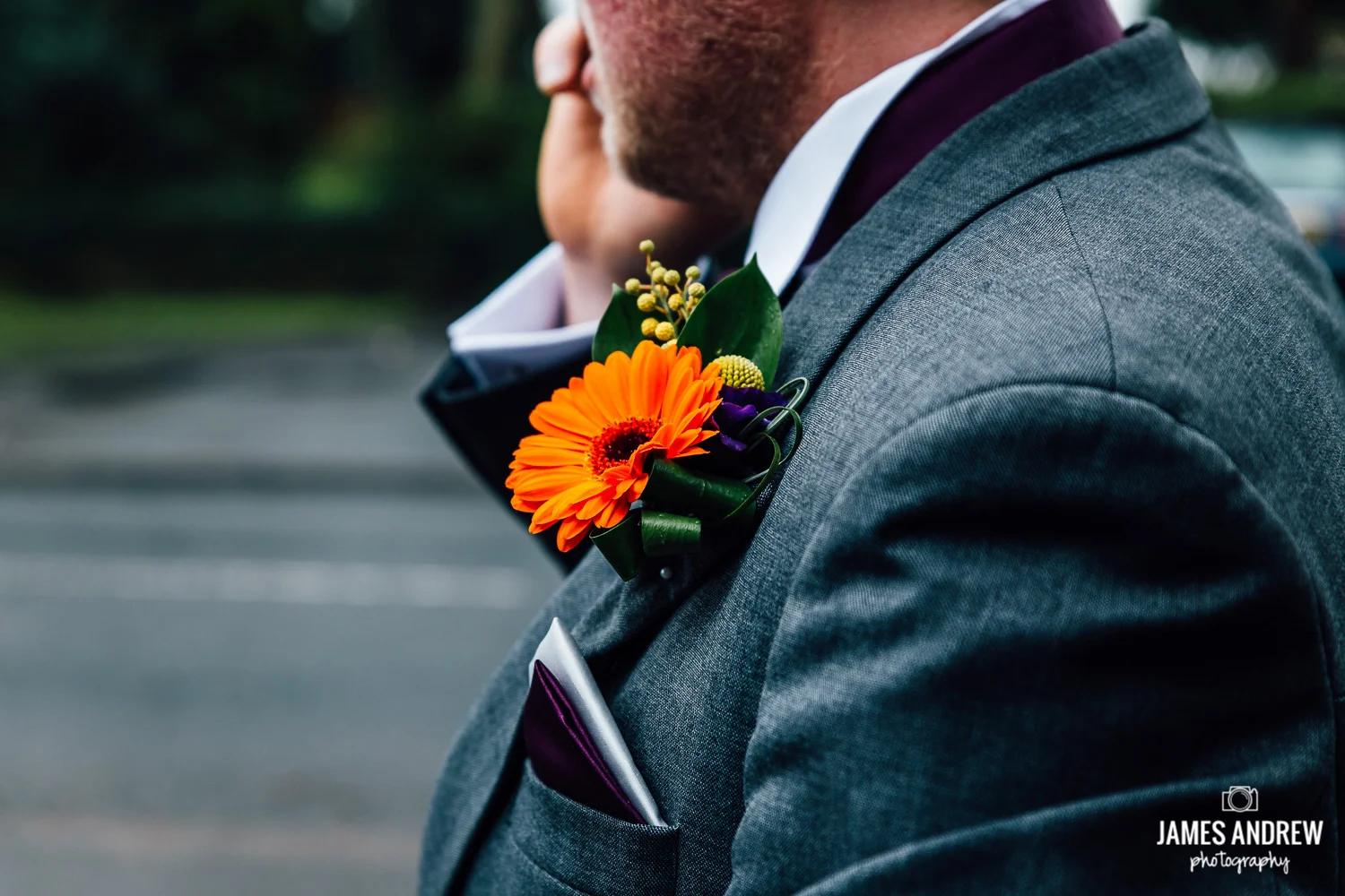 groom button hole flower orange