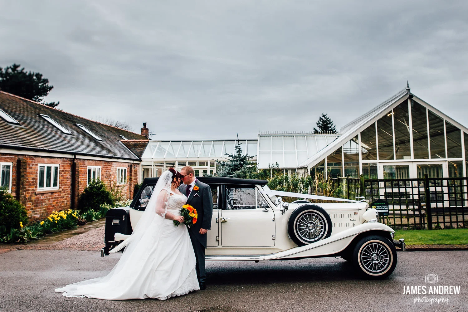 bride and groom with vintage wedding car at abbeywood estate cheshire