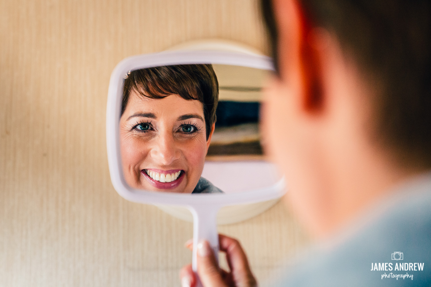 bride getting ready looking in mirror