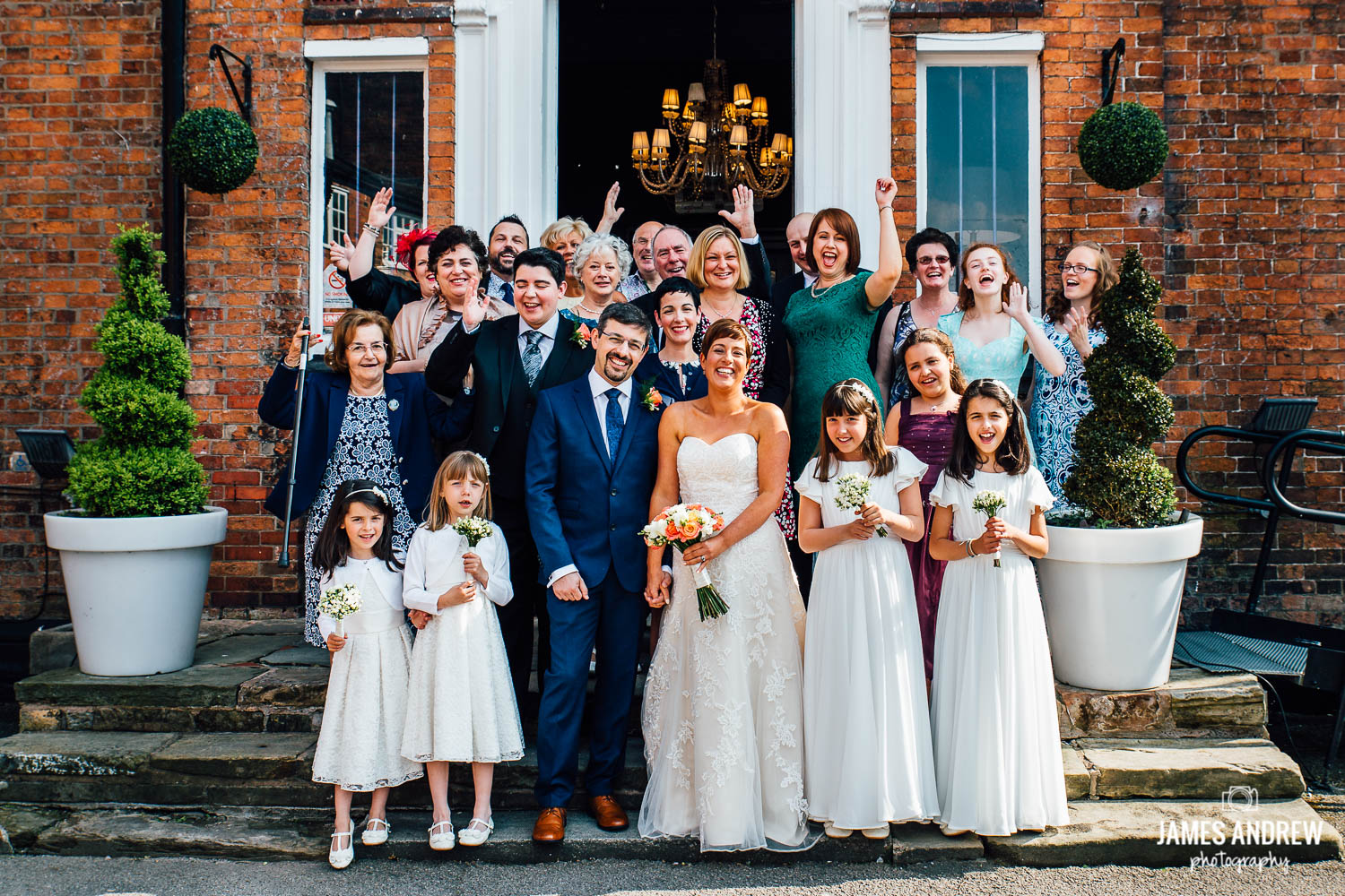 group picture of whole wedding party outside