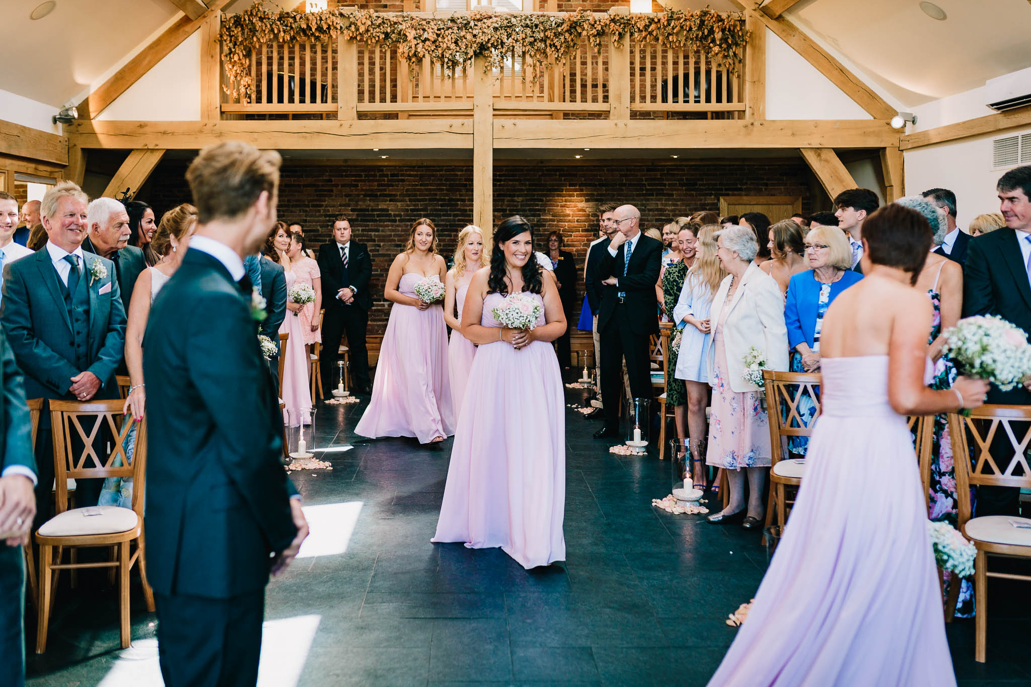 BRIDESMAIDS WALKING DOWN THE ISLE IN CHURCH