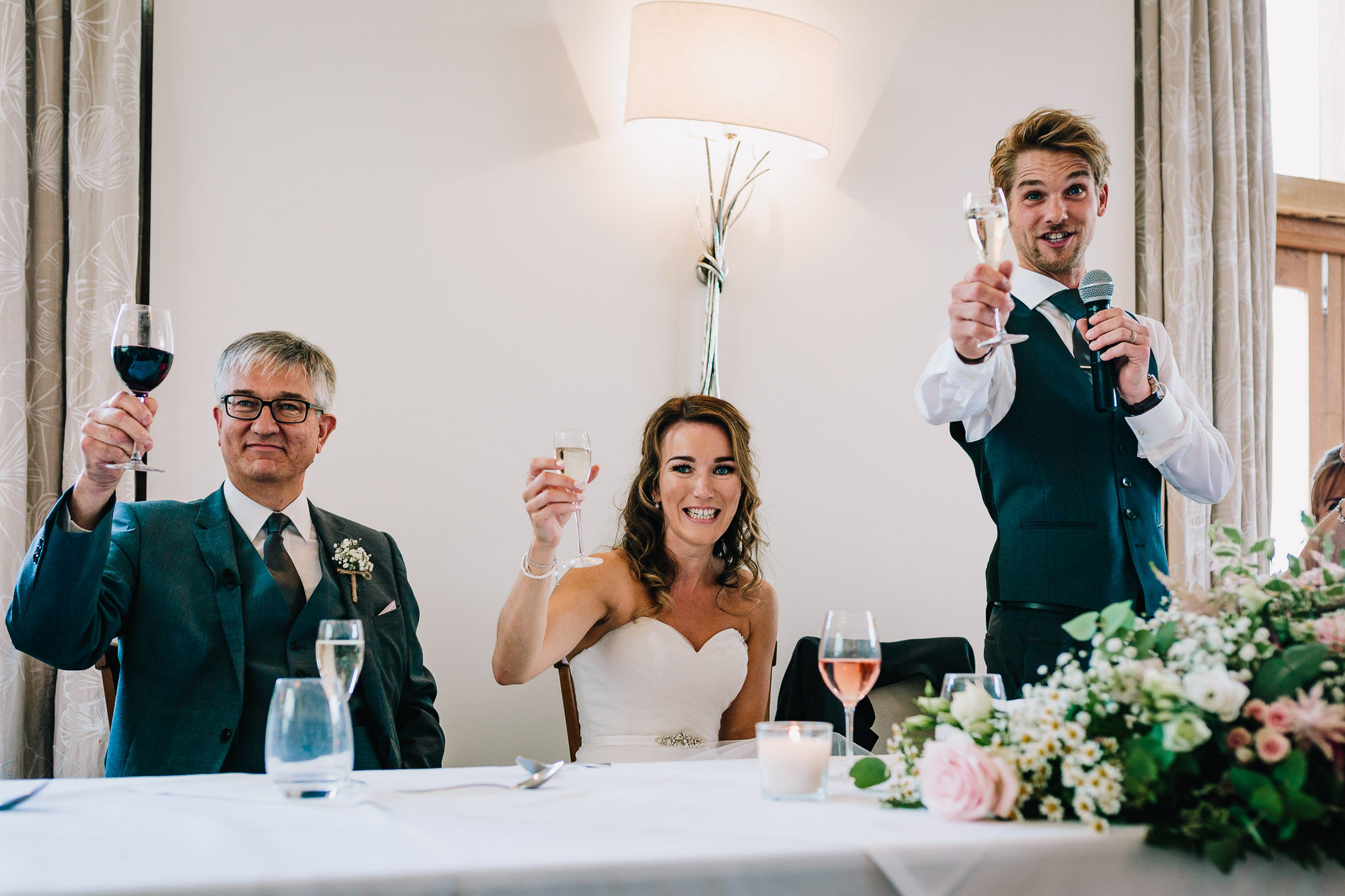 BRIDE AND GROOM TOASTING WITH CHAMPAGNE GLASSES CHEERS