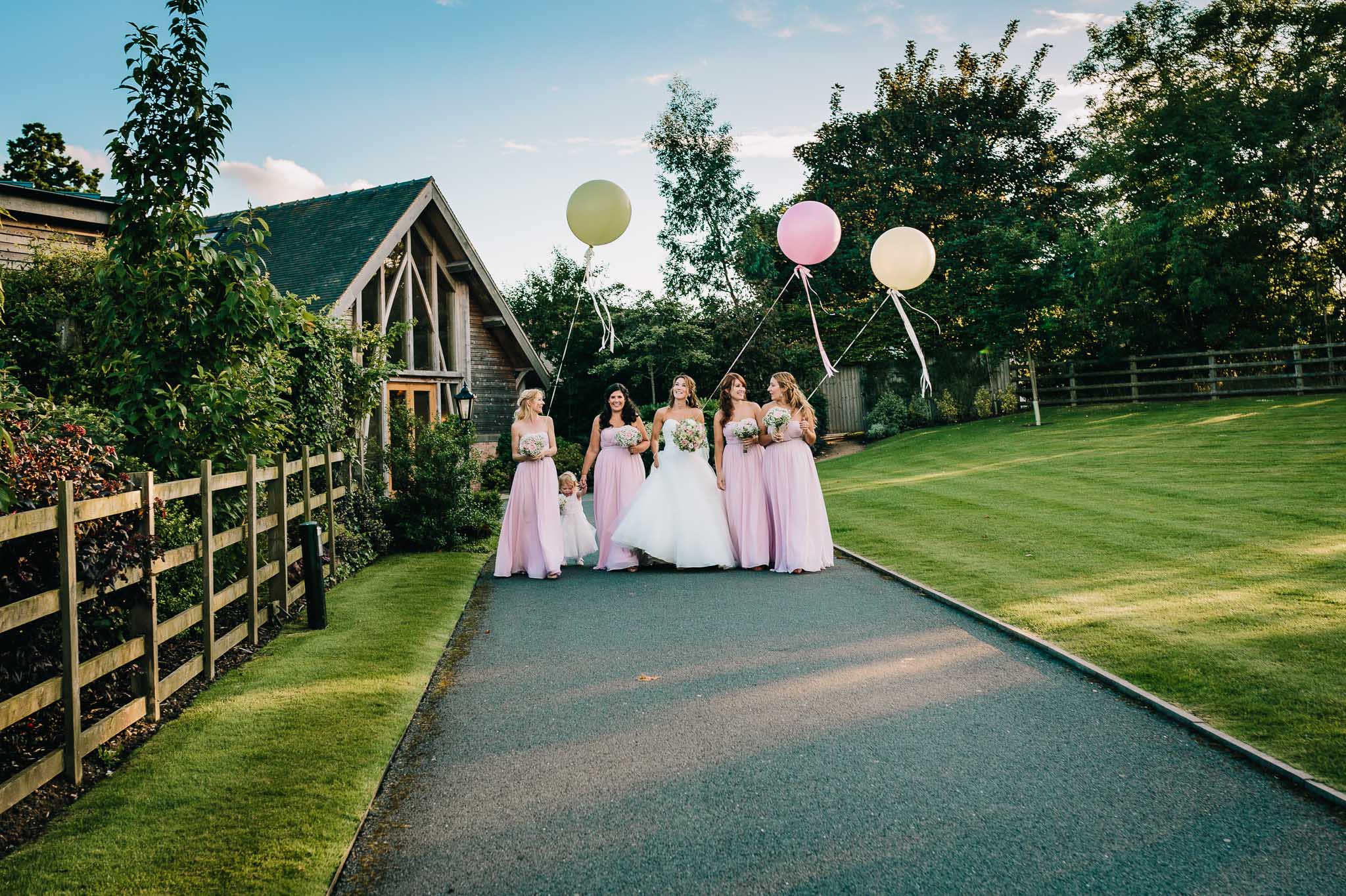 BRIDESMAIDS PORTRAITS WALKING WITH BALLOONS
