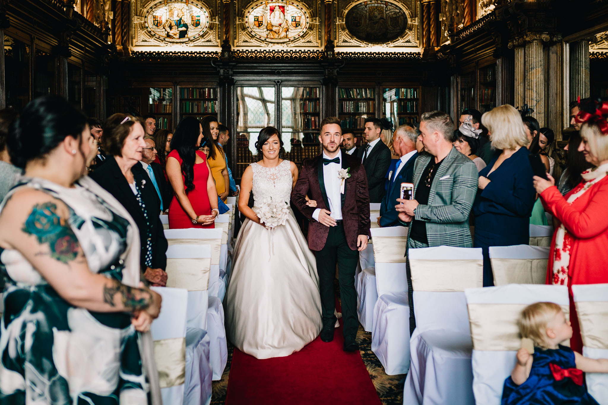 BRIDE WALKING DOWN THE ISLE WITH HER BROTHER AT WEDDING