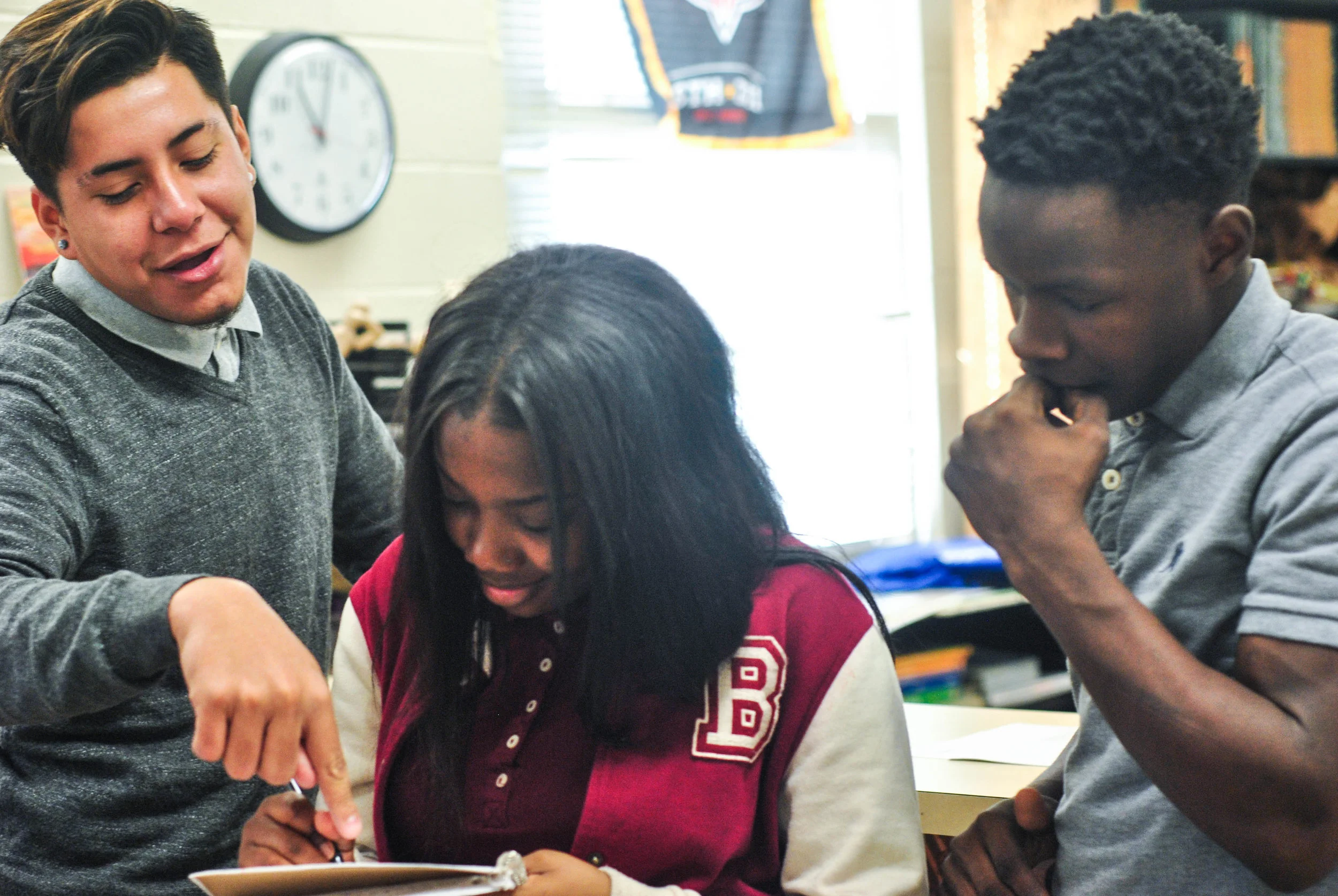 Howard students review drawings for the "To Thine Be True" mural.