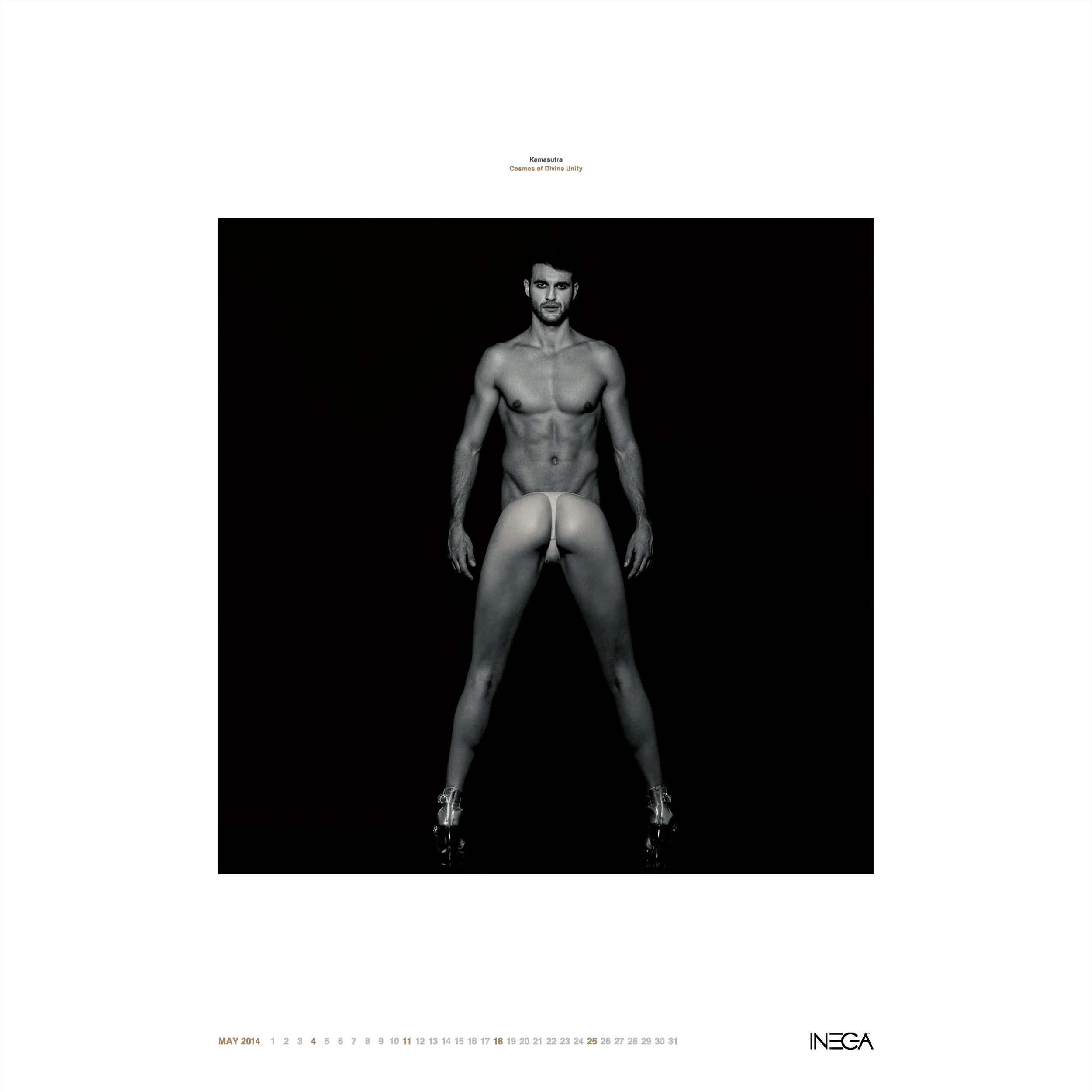 Black and white photo of a shirtless man with a confident expression, standing with legs apart and hands relaxed at sides, against a dark background. He is wearing high-heeled shoes and the photo has a minimalist, artistic style. The top features sma