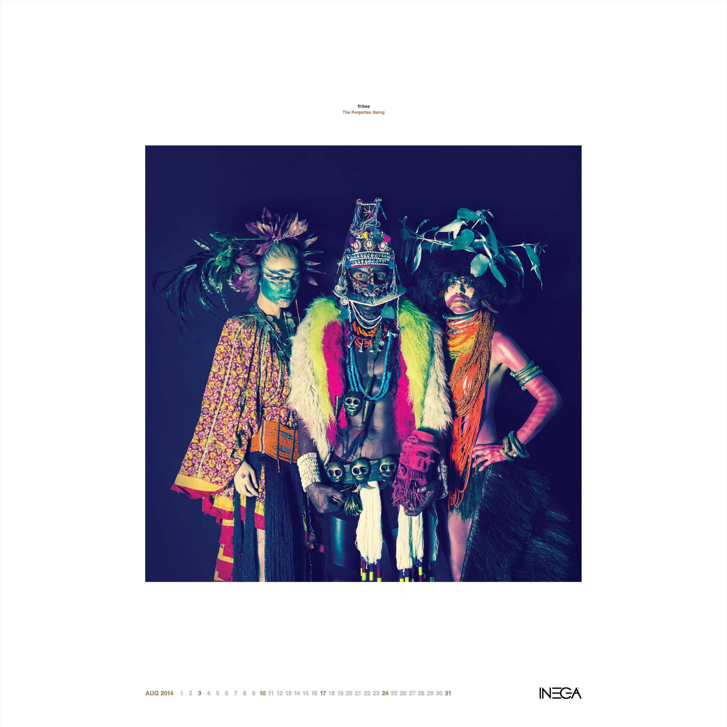 Three individuals dressed in elaborate, colorful tribal costumes with accessories, face paint, and natural elements like leaves and feathers, standing against a dark background.