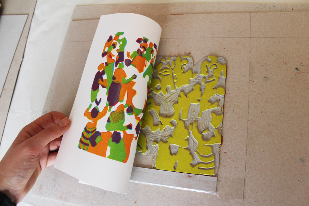 Peeling back the print after it's been in the press - the yellow has overlayed with the blue to make green and the red to make orange