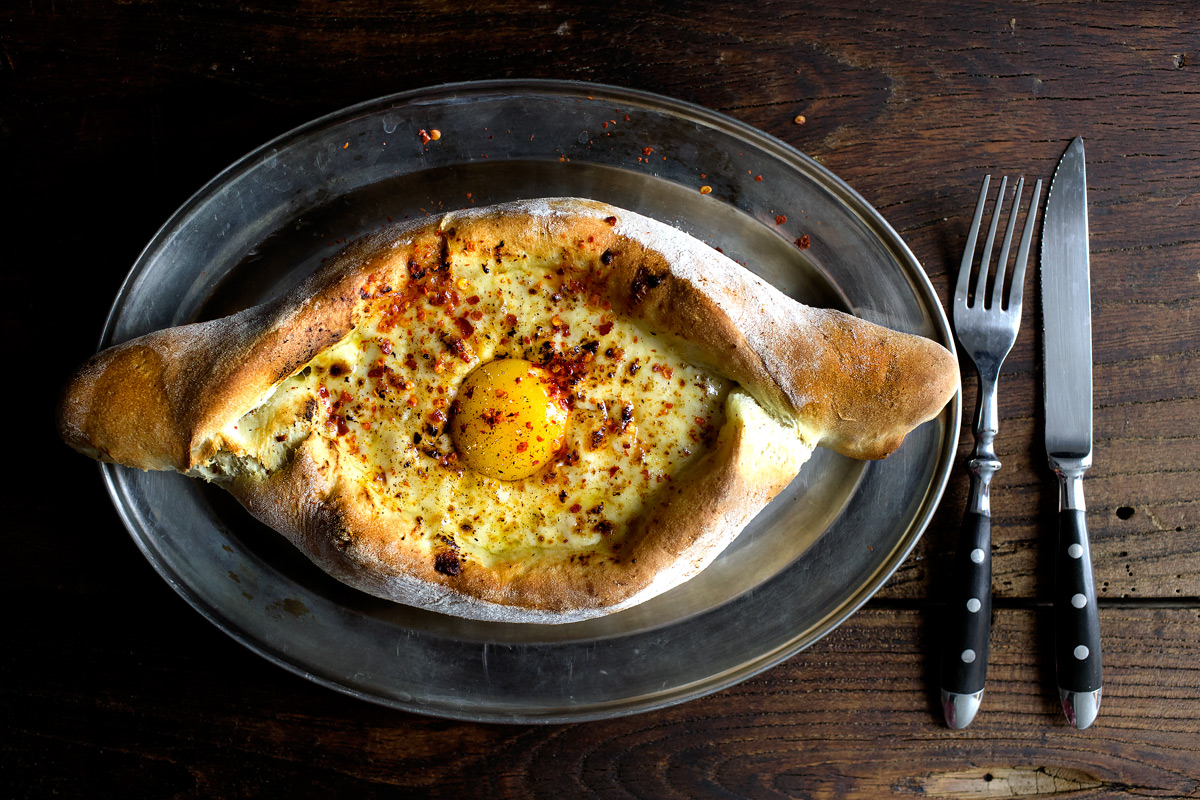 A tasty Khachapuri , a georgian bread with melted cheese and egg like you can eat in places like Shoti or Gogi.
