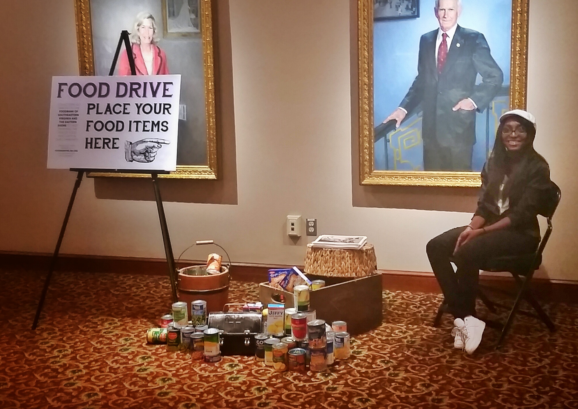 #ARTwithaTWIST winner Aaliyah Pitts in the food drive collection area. She was able to hand out her print and discuss her piece with our patrons throughout the night! 