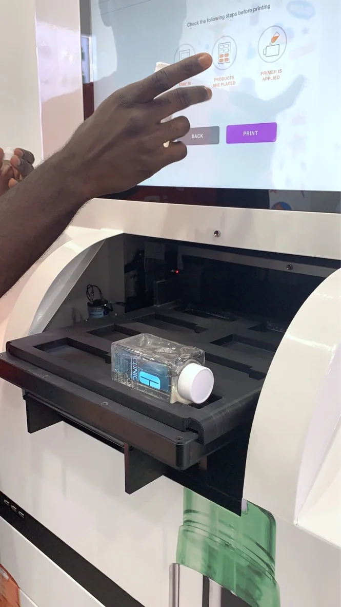 The graphic wrap on the printer showcases the bottle+cartridge system, textures, and patterns. It was featured in a pop-up event in Soho, NYC, and is available in select retail locations and online.