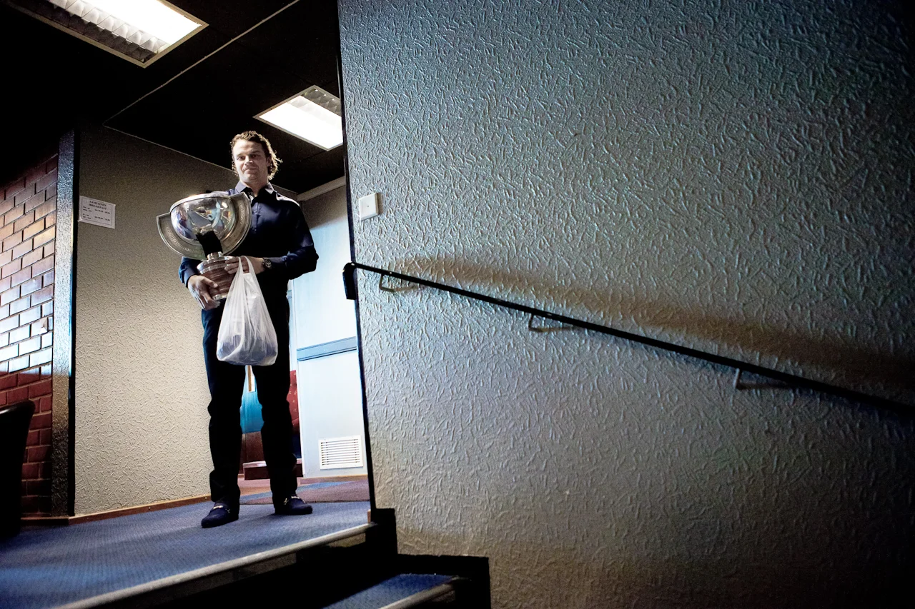 Janne Pesonen holds the ice hockey world champion trophy. Medal and the game jersey are in the plastic bag. © Kainuun Sanomat