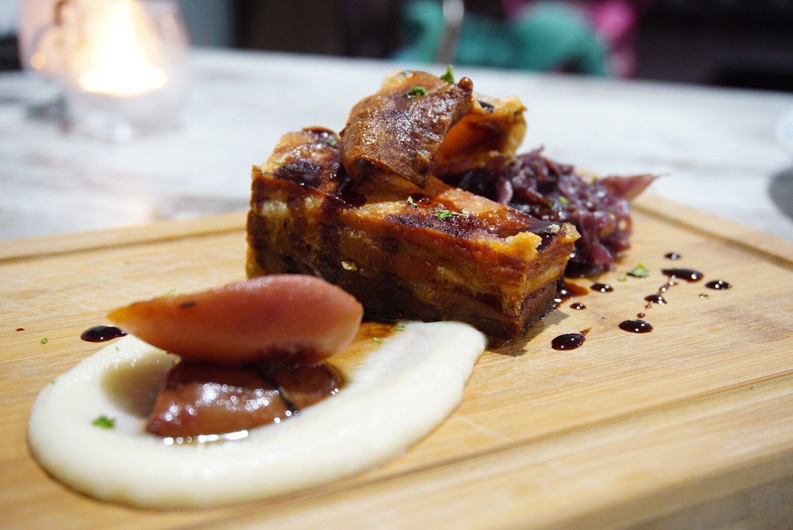 Roast pork belly with cauliflower puree, braised red cabbage and pulled pork croquette