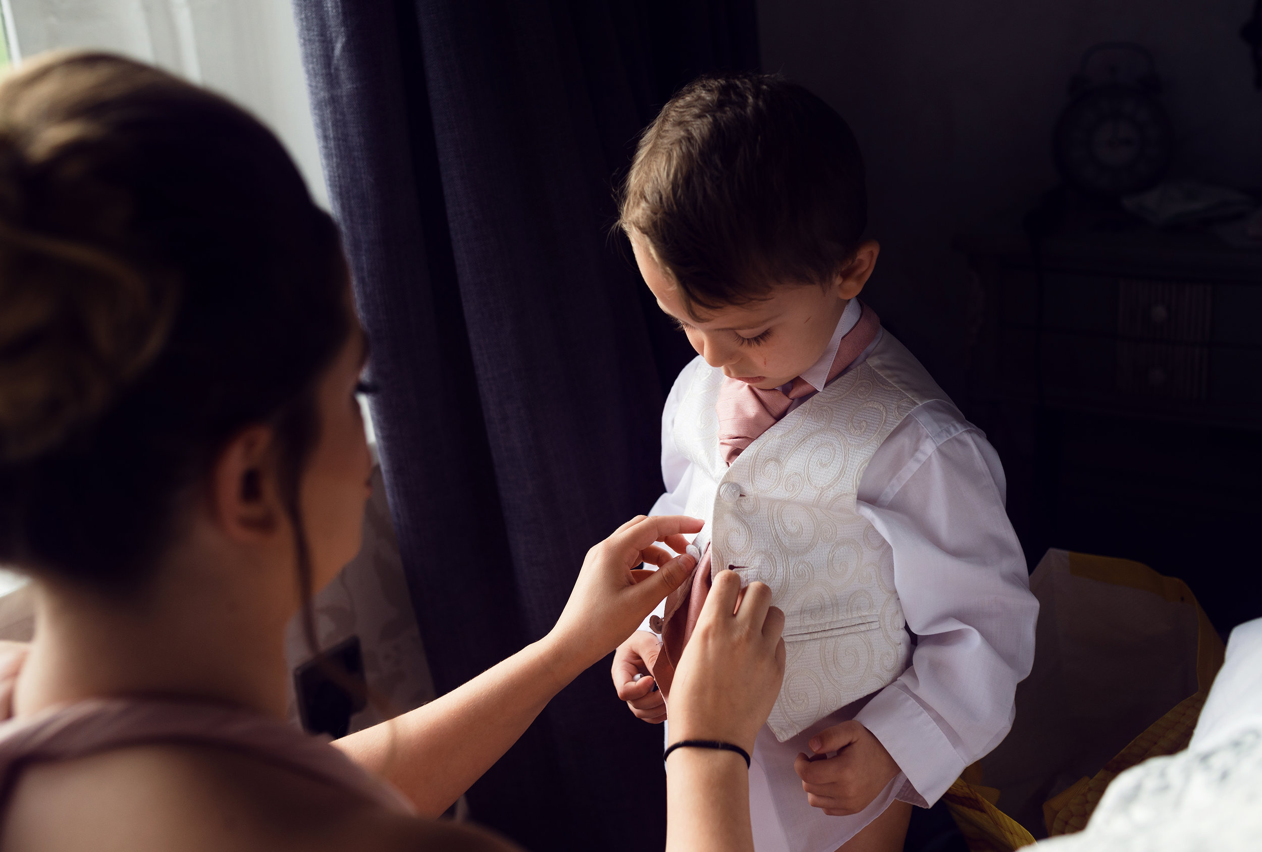 Smart pageboy getting ready for the wedding