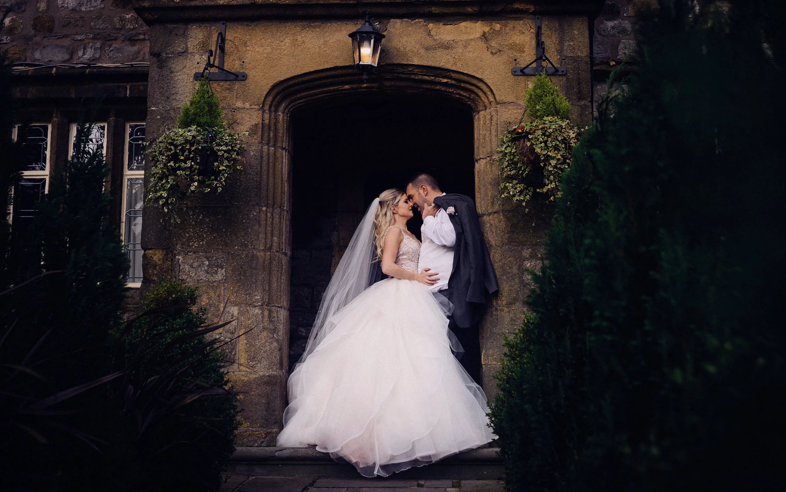 The bride and groom in the main doorway at Strik House