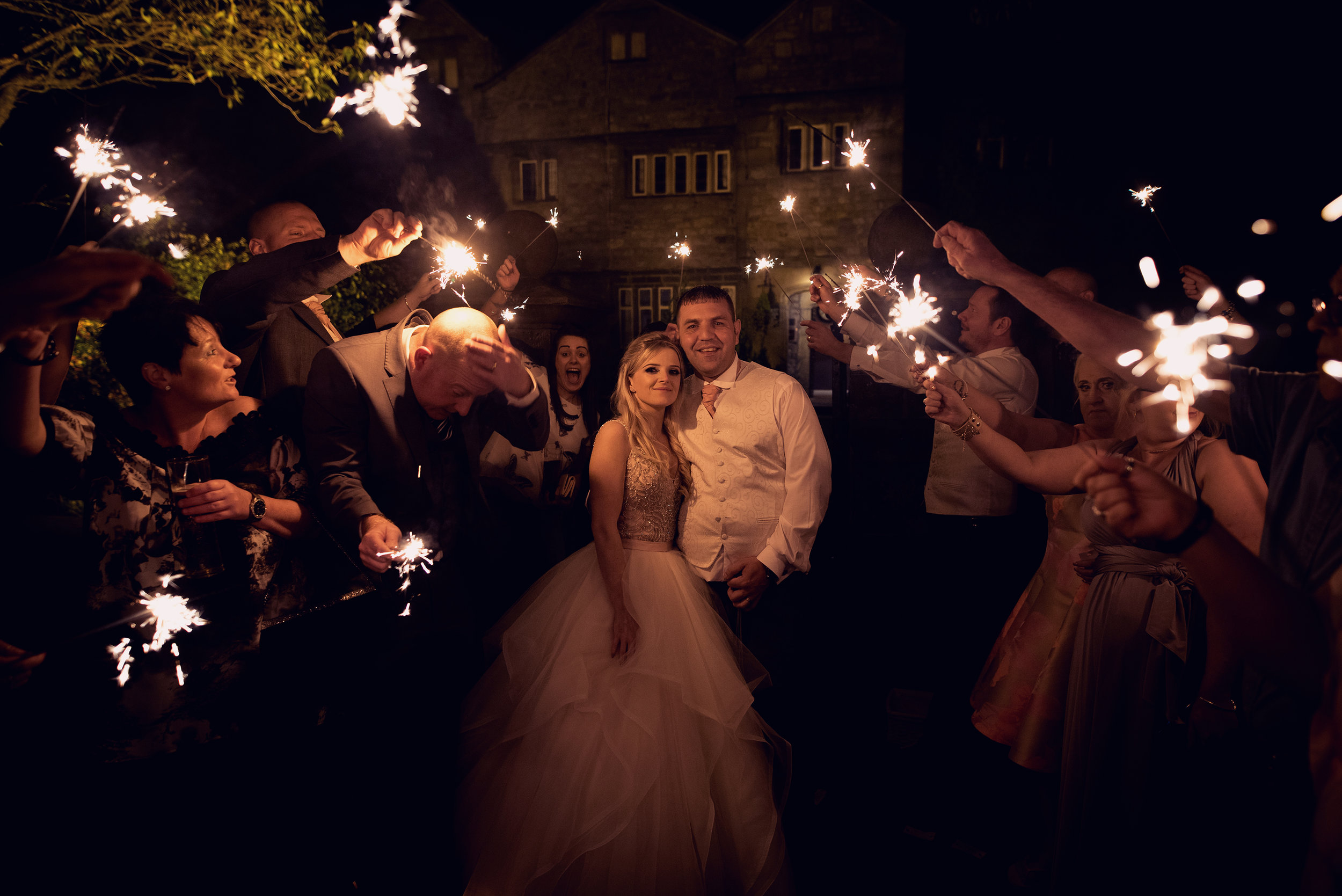 Bride and Groom with guests and sparklers