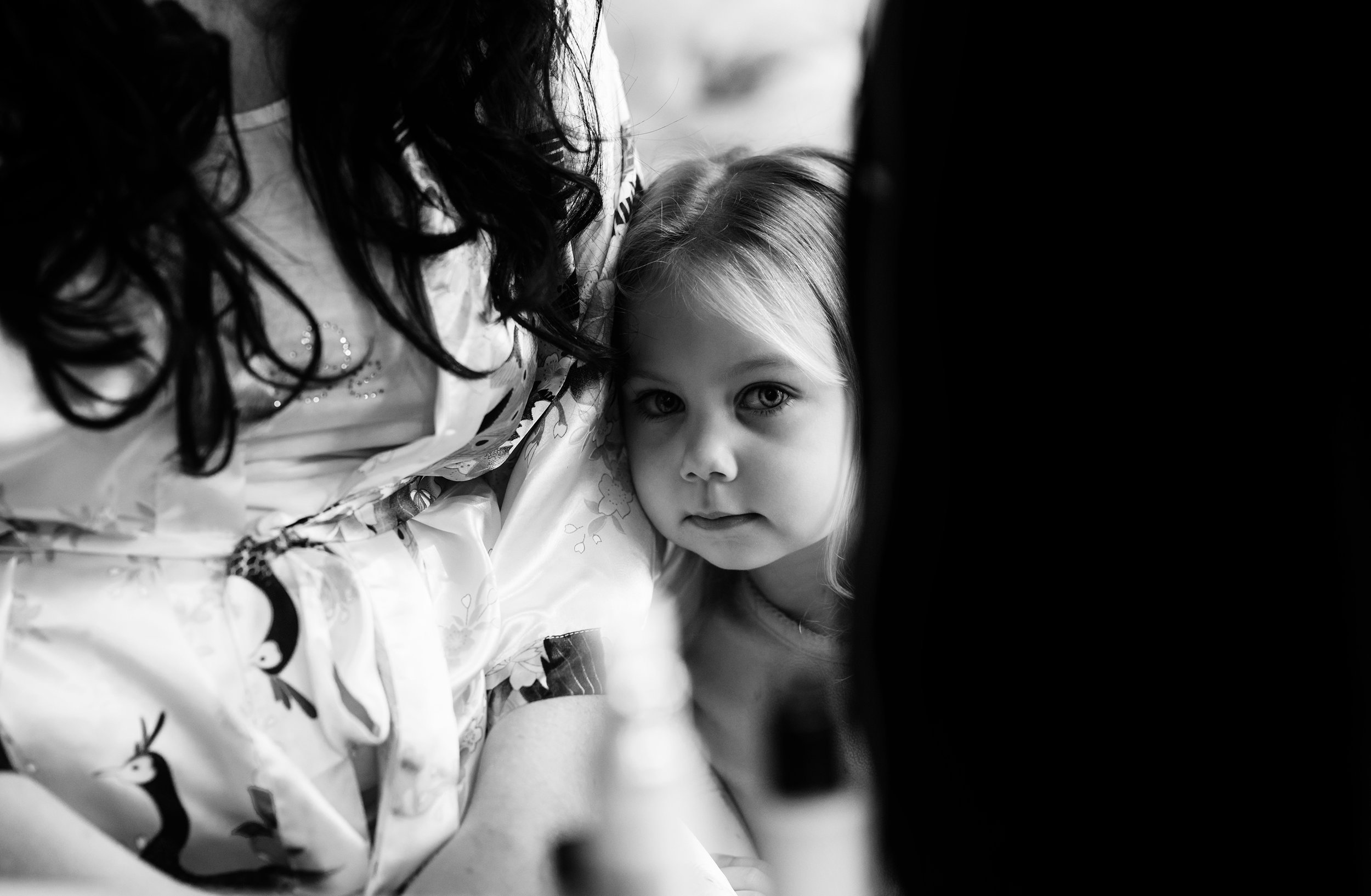 Little flower girl trying to hide from me during bridal preparations