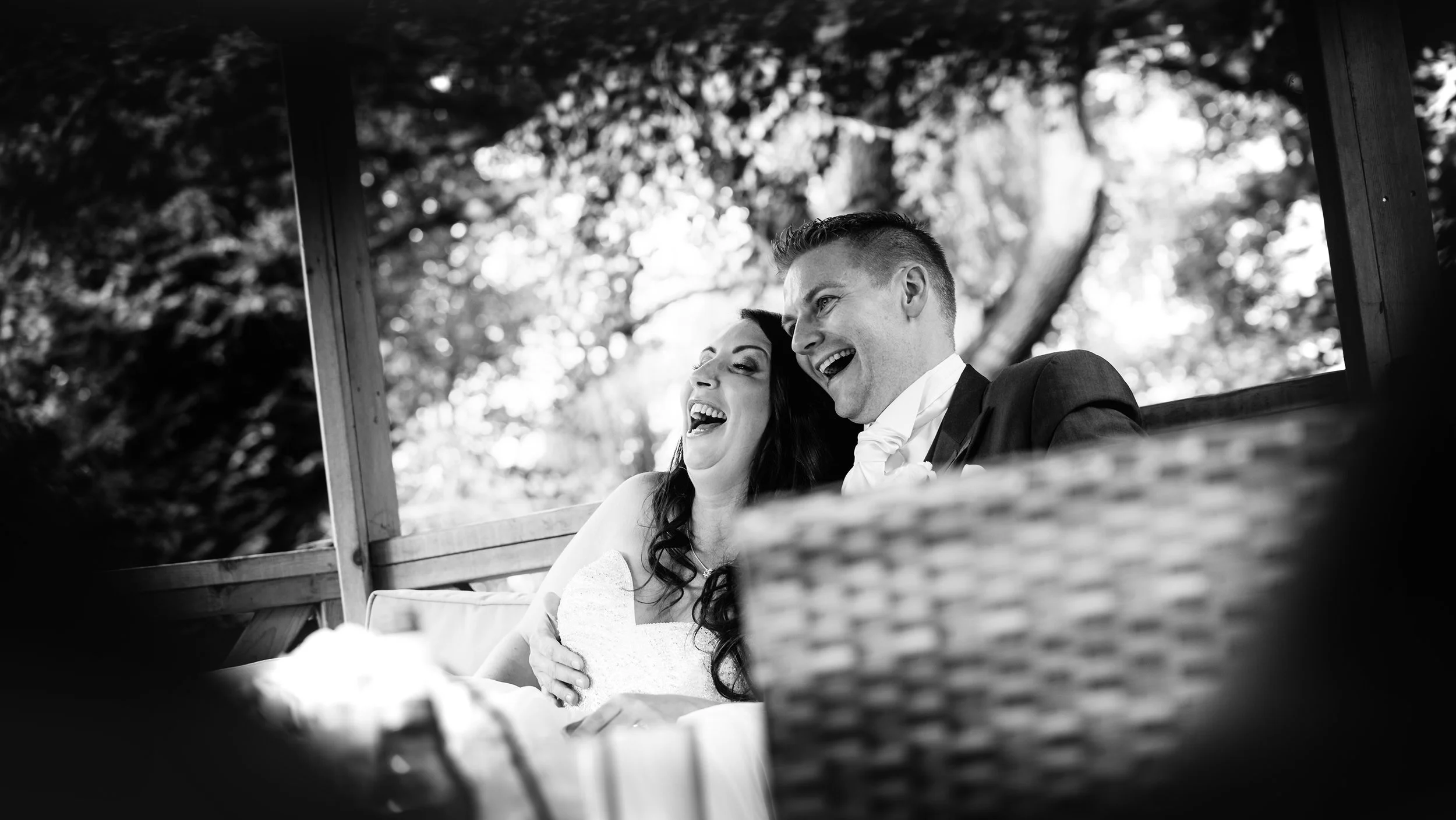 The bride and groom totally chilled out relaxing in the garden chairs