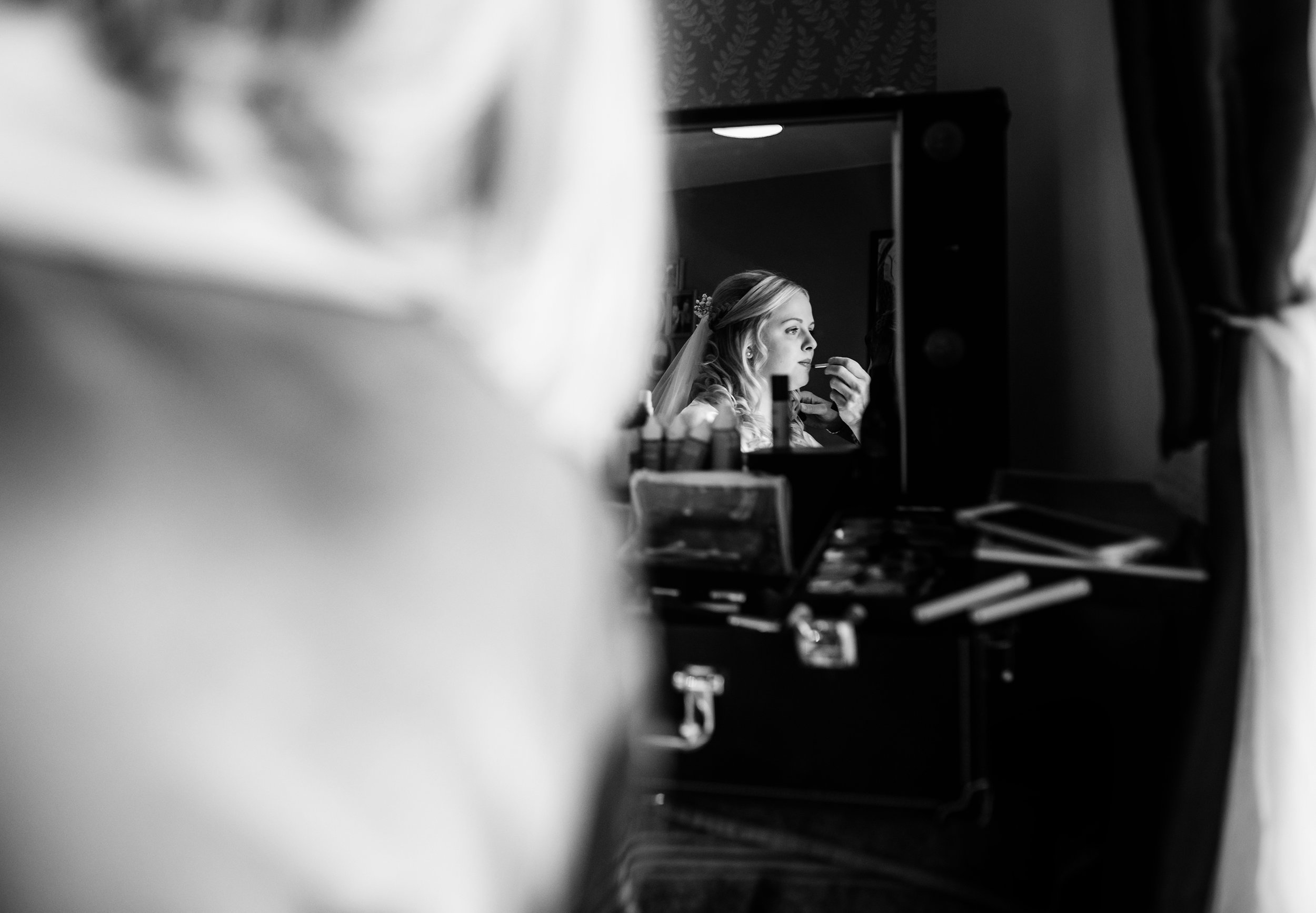 Bridal portrait though a mirror during morning preparations