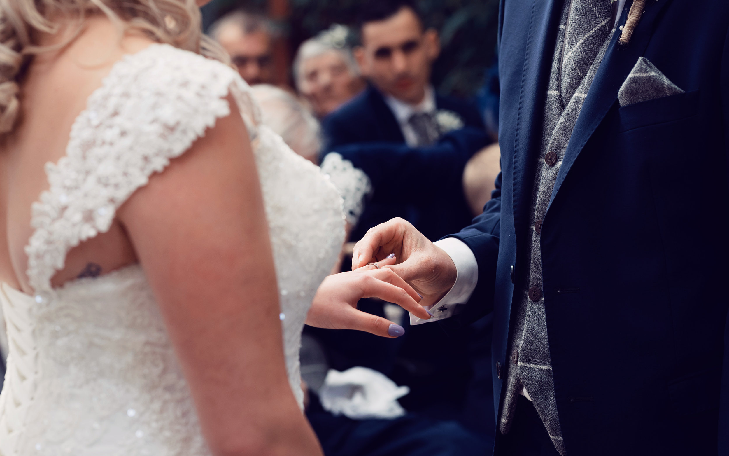 The happy couple exchanging wedding rings