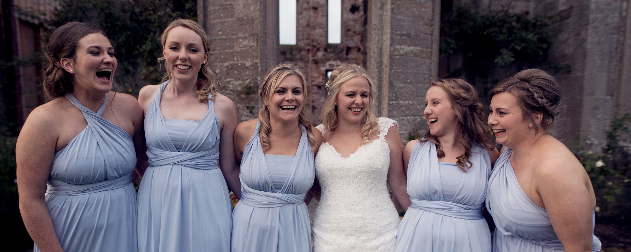 Bride and her bridesmaids having a good laugh