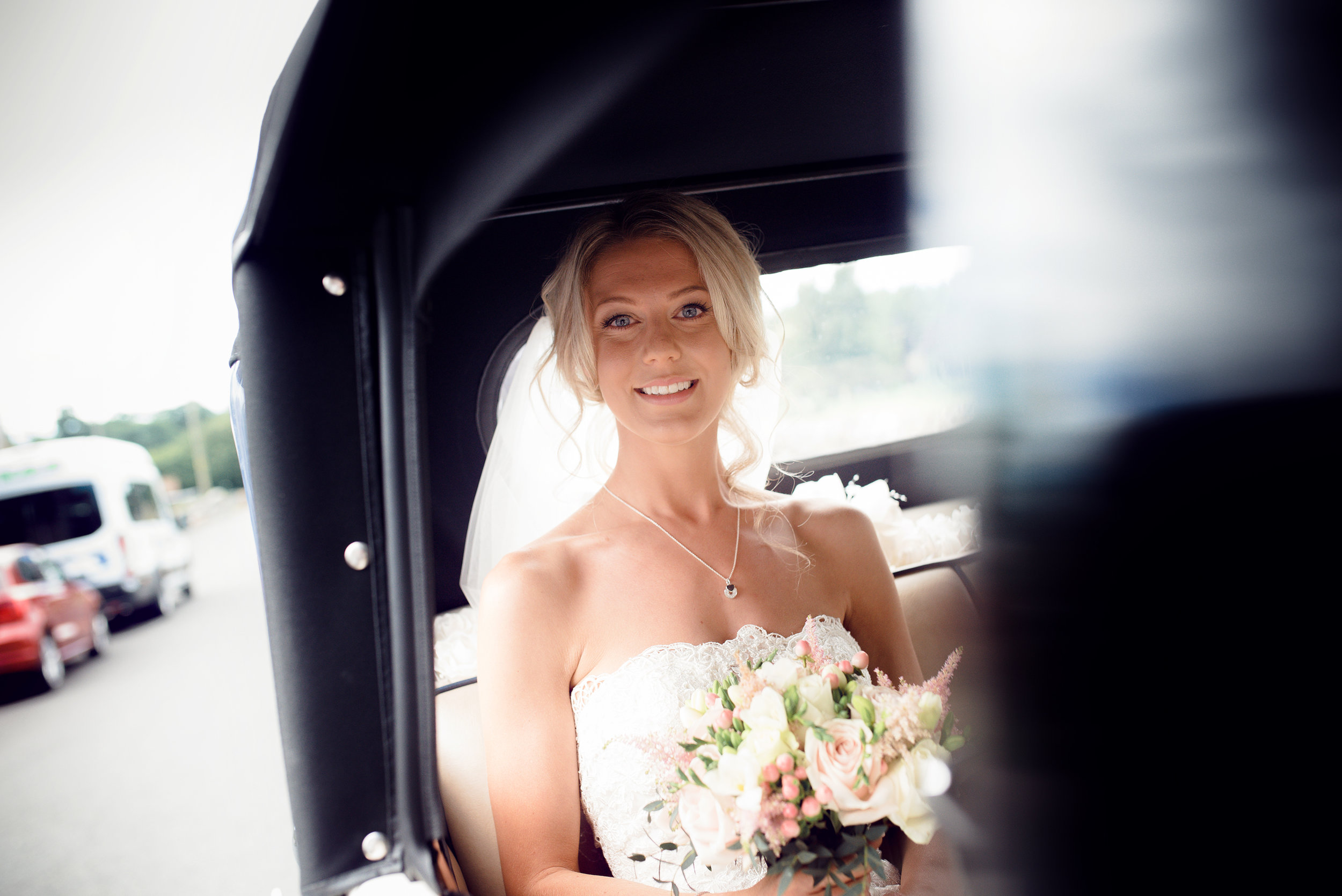 The bride sitting in the car arriving at the church