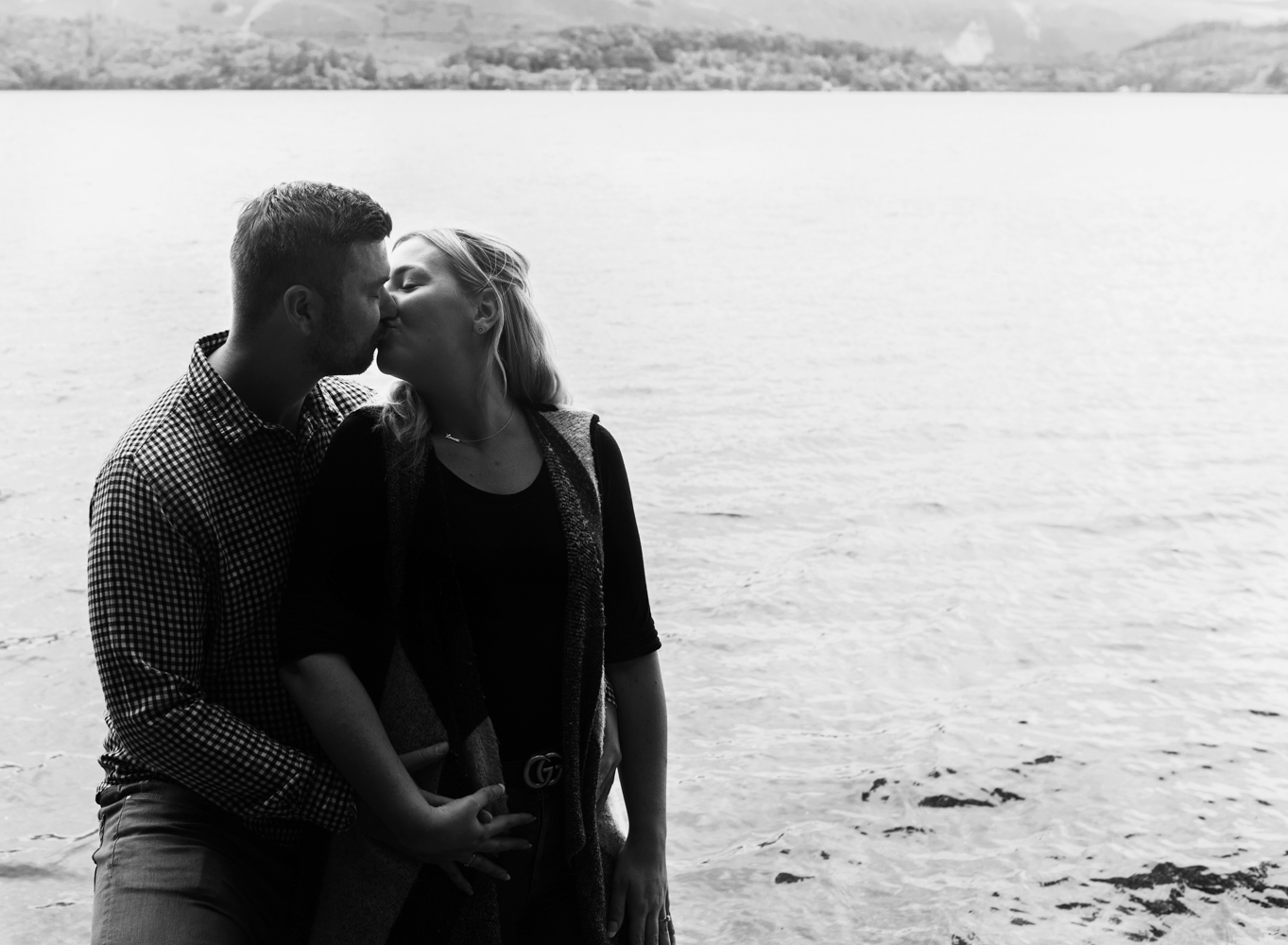 Couple kissing on the lake shore