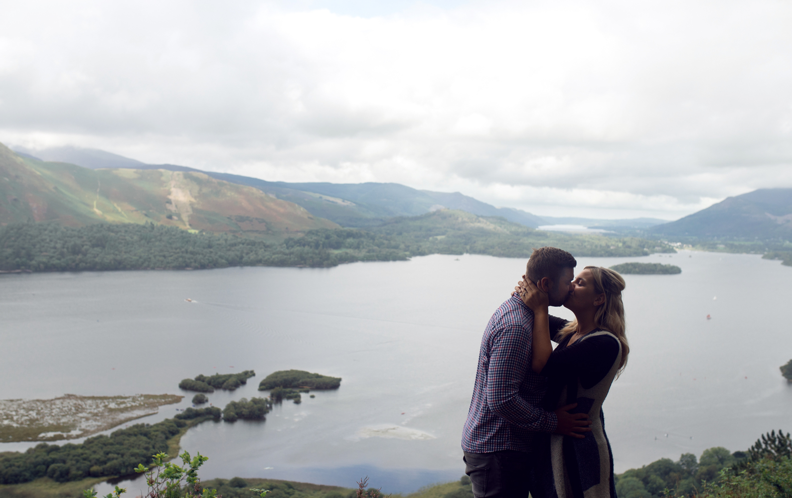 Laura and Johnny kissing with Derwent water in the background