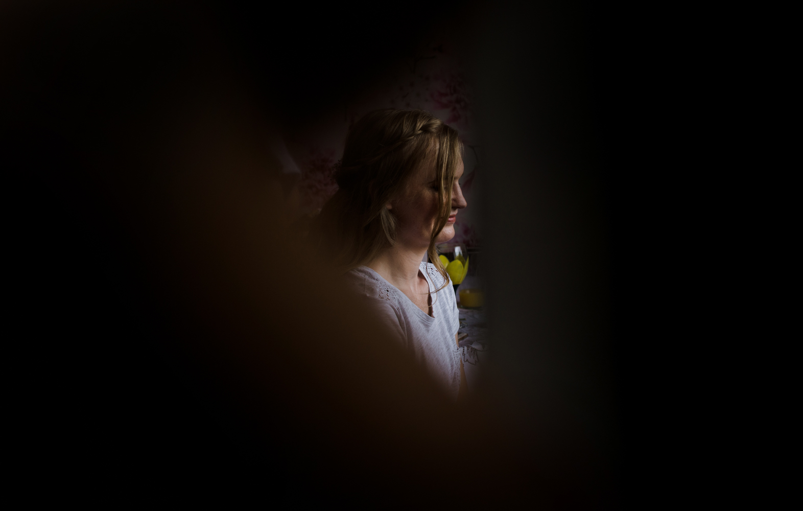 obscured view of a bridesmaid during bridal preparations