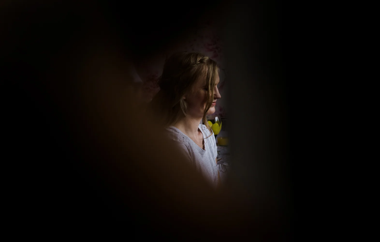 obscured view of a bridesmaid during bridal preparations