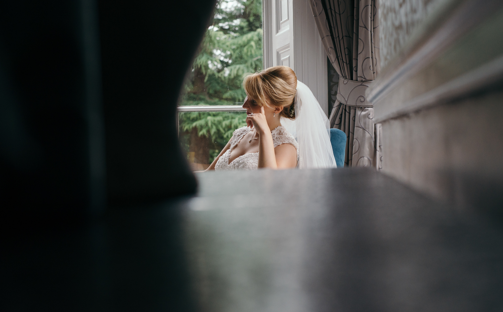 candid shot of the bride relaxing during the drinks reception at Mottram Hall